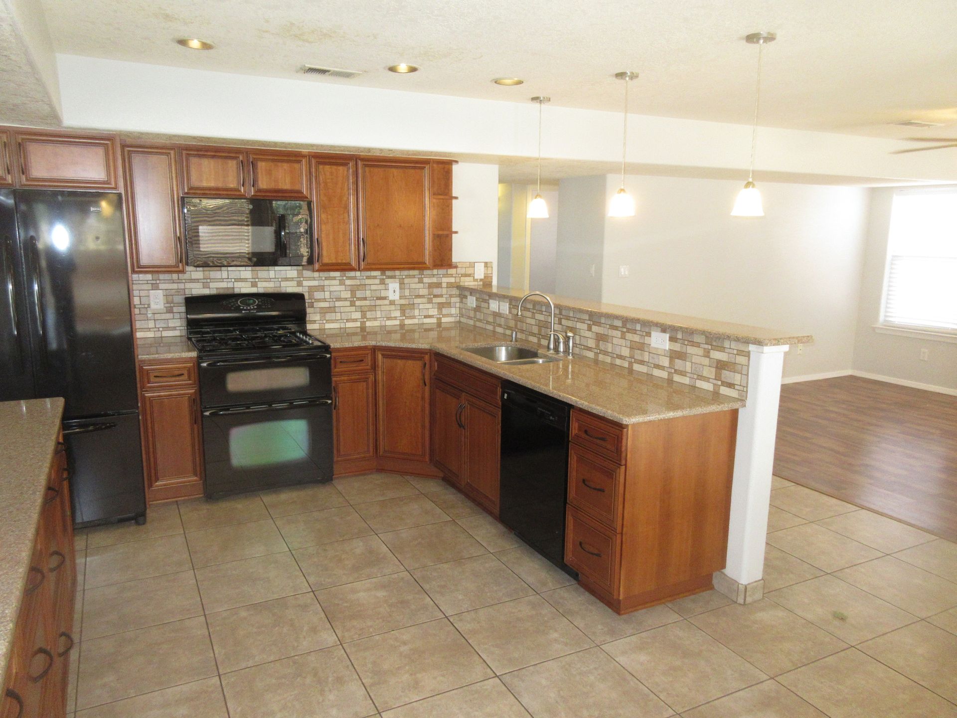 A kitchen with stainless steel appliances and wooden cabinets