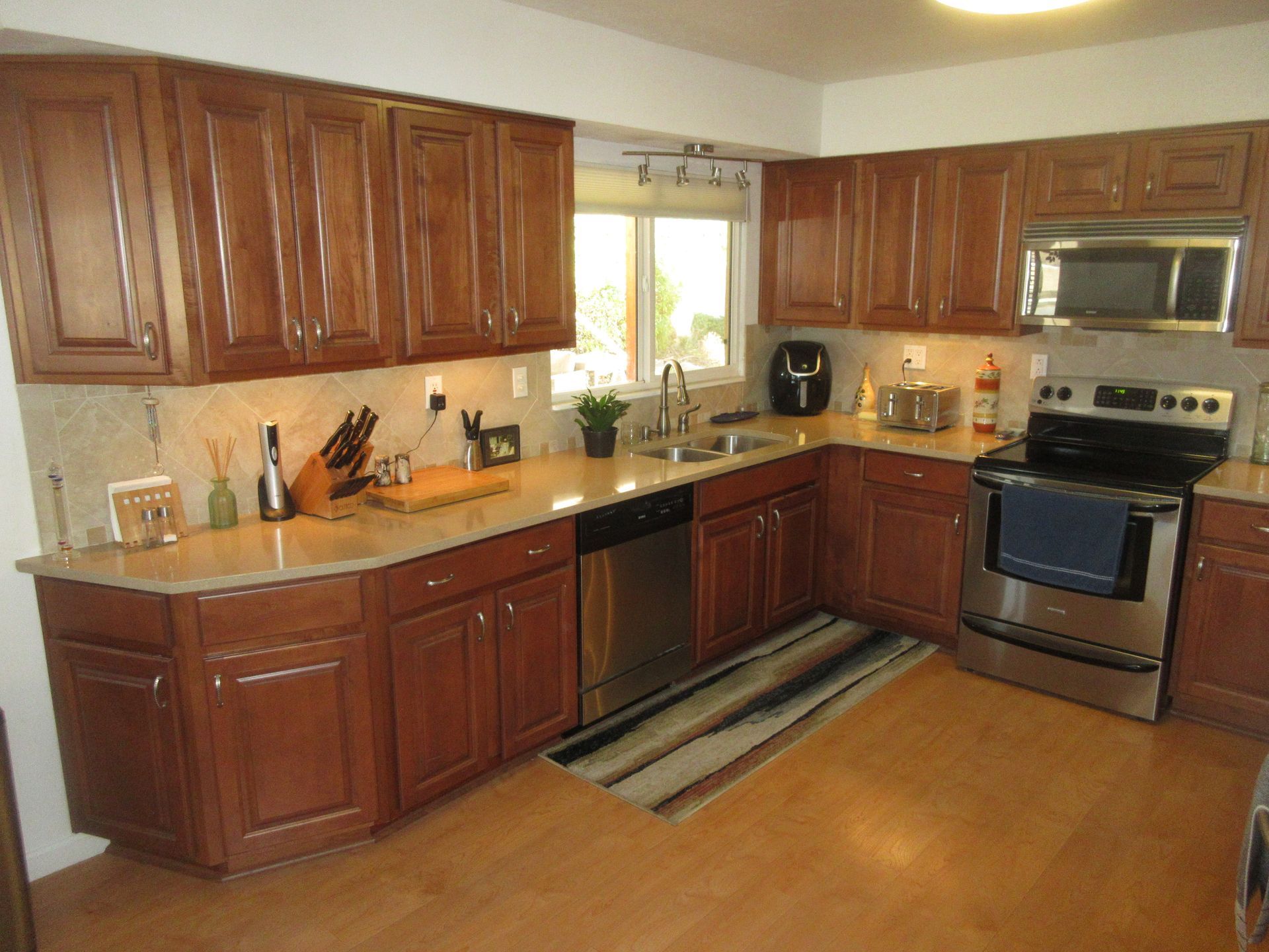 A kitchen with stainless steel appliances and wooden cabinets