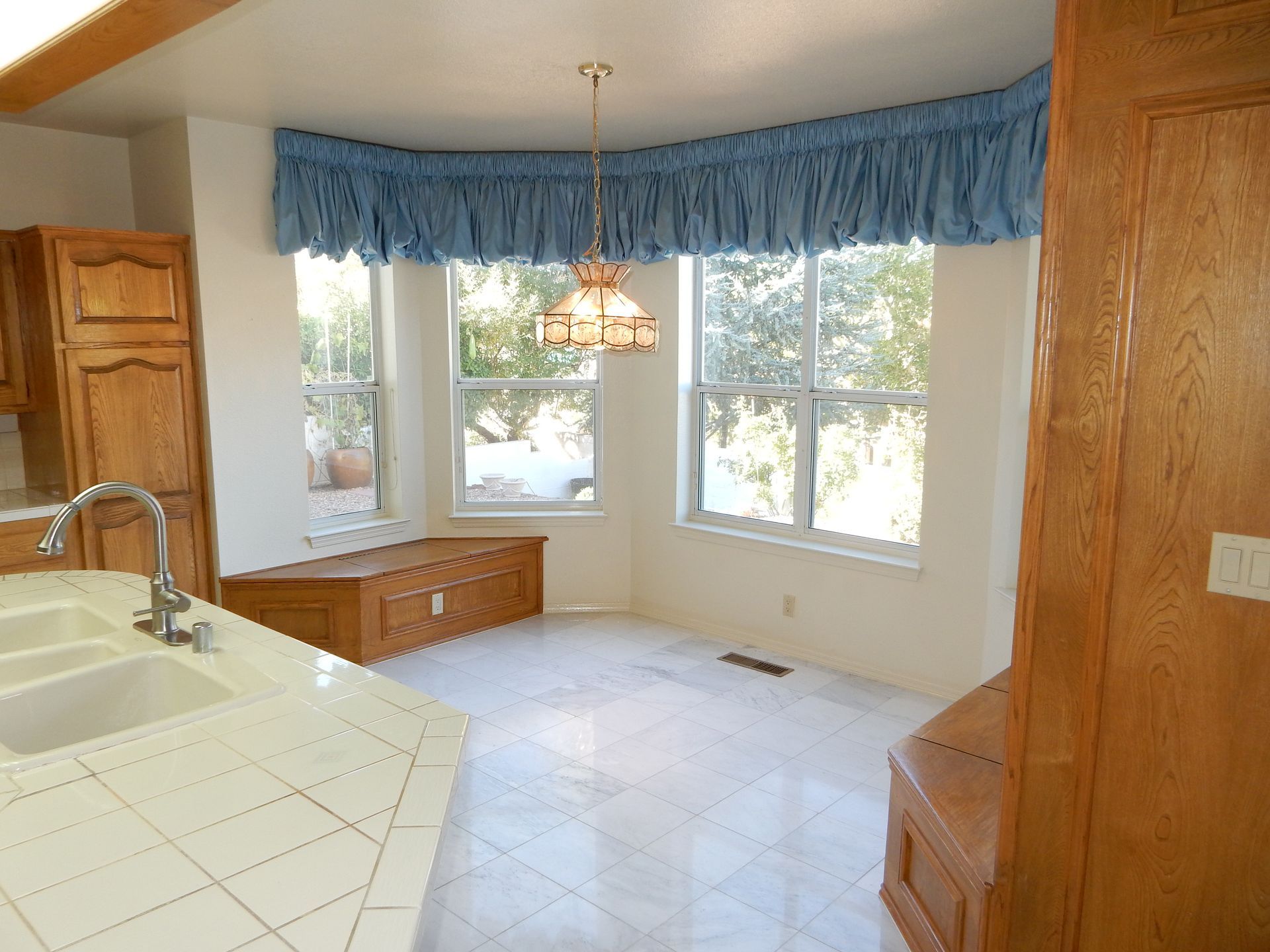 An empty kitchen with a sink and a window