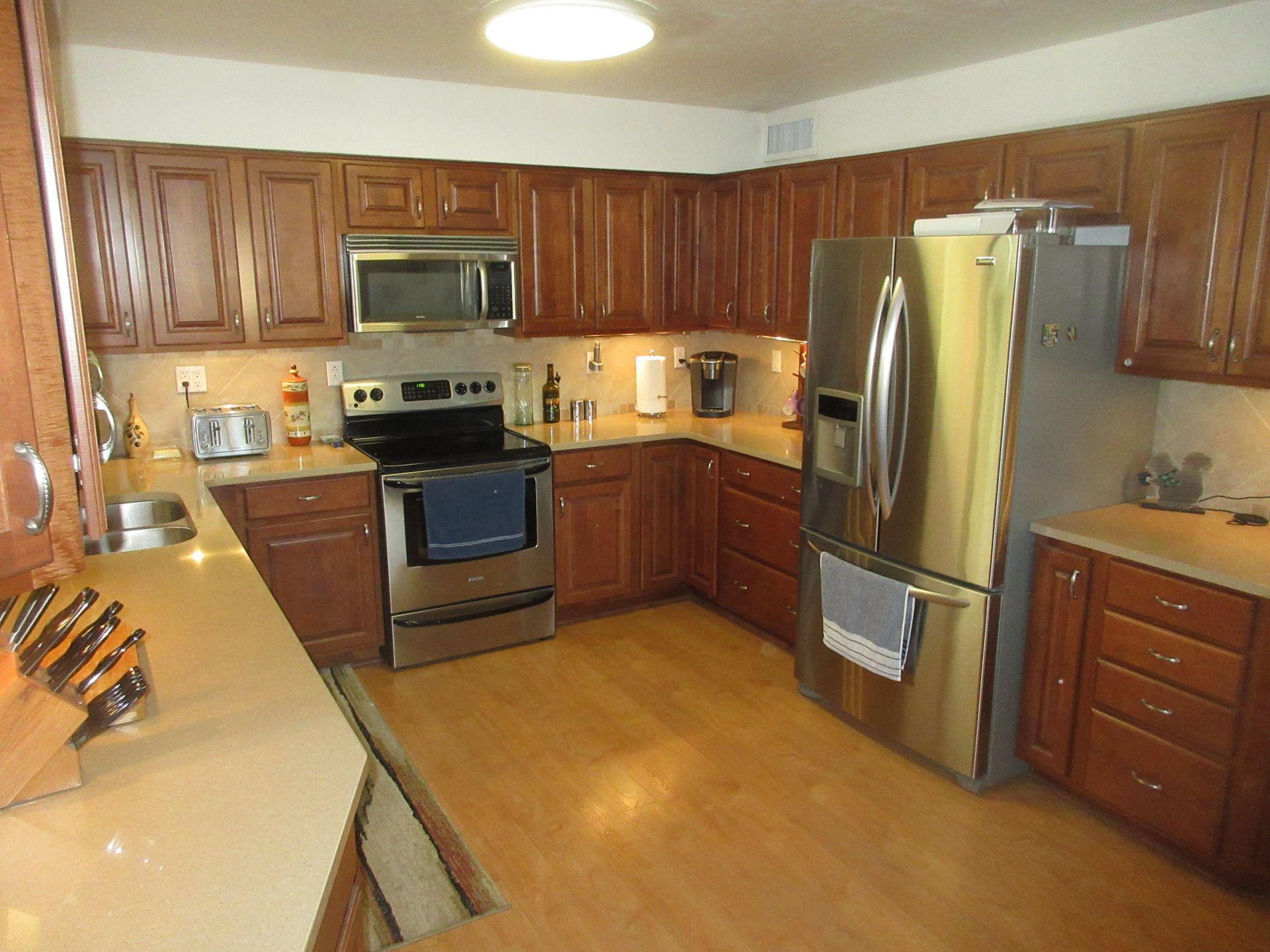 A kitchen with stainless steel appliances and wooden cabinets