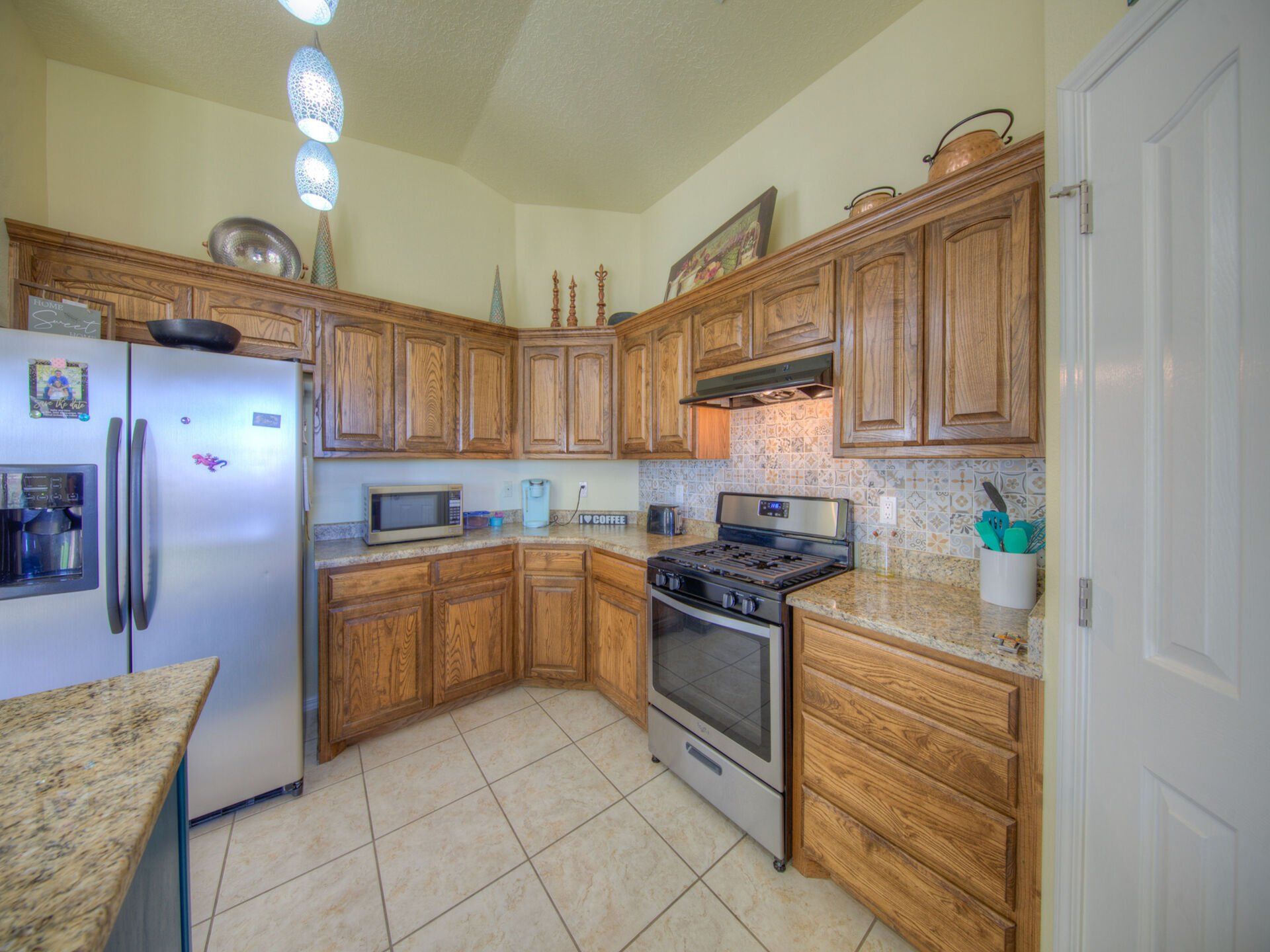 A kitchen with stainless steel appliances and wooden cabinets