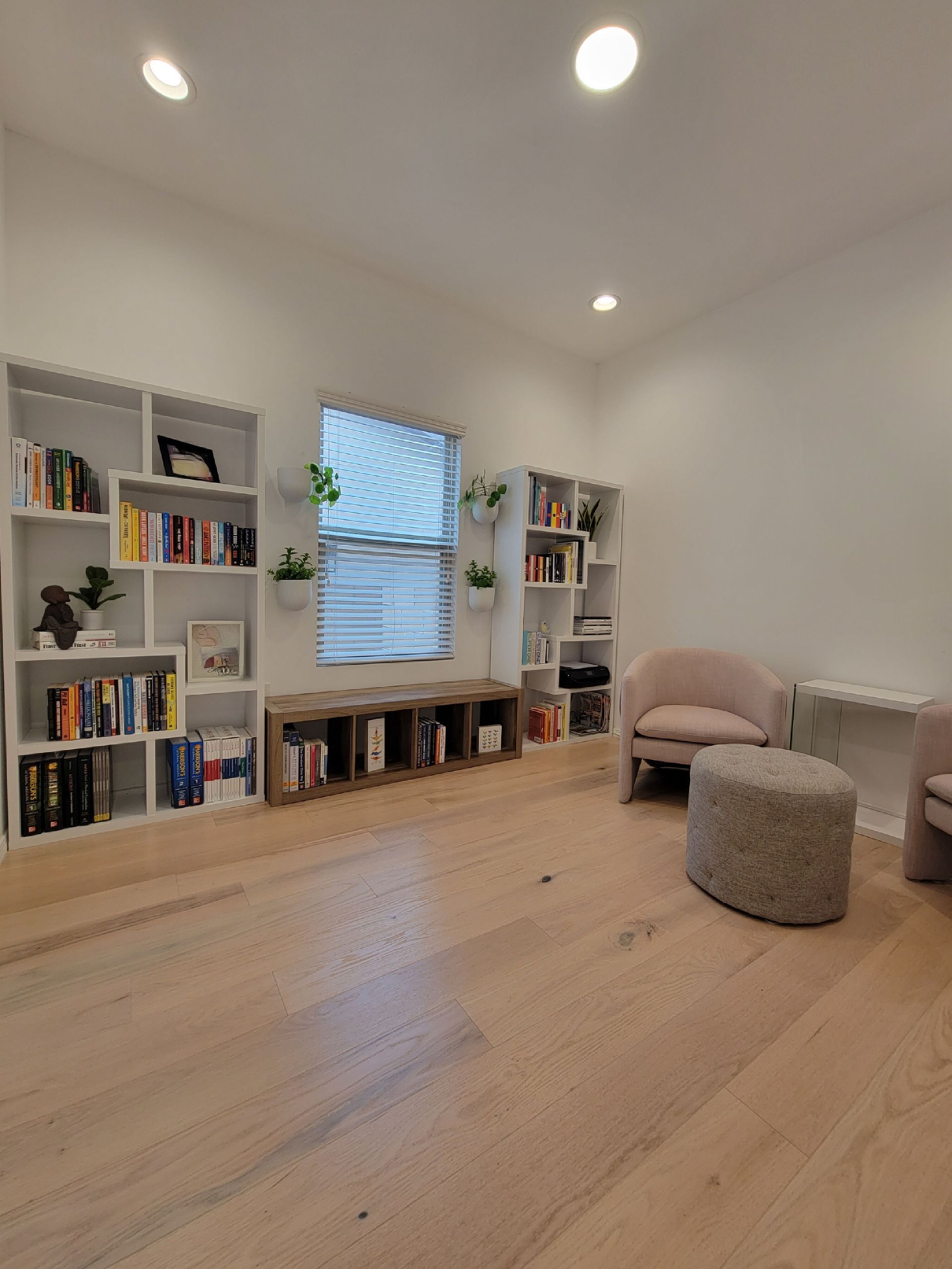 A living room filled with furniture and bookshelves.