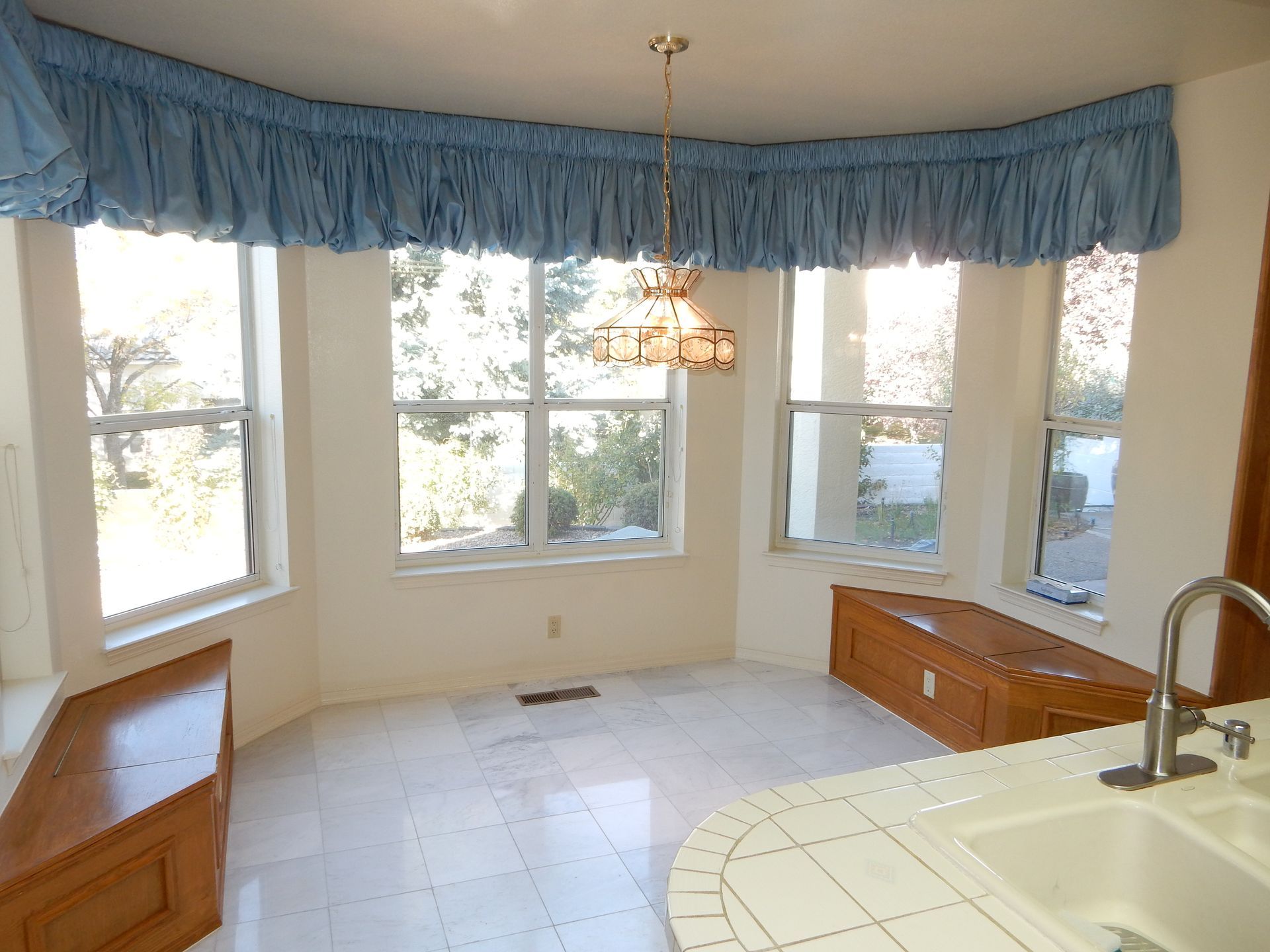 A kitchen with a large window and a sink