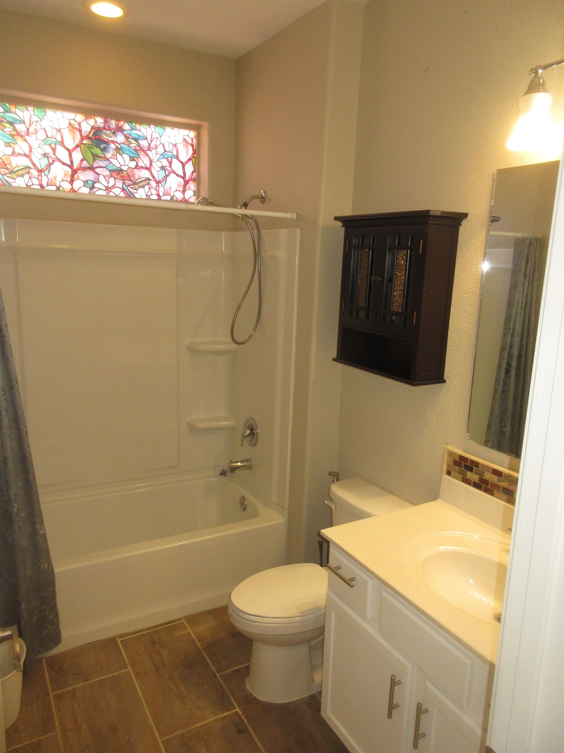 A bathroom with a toilet a sink and a bathtub