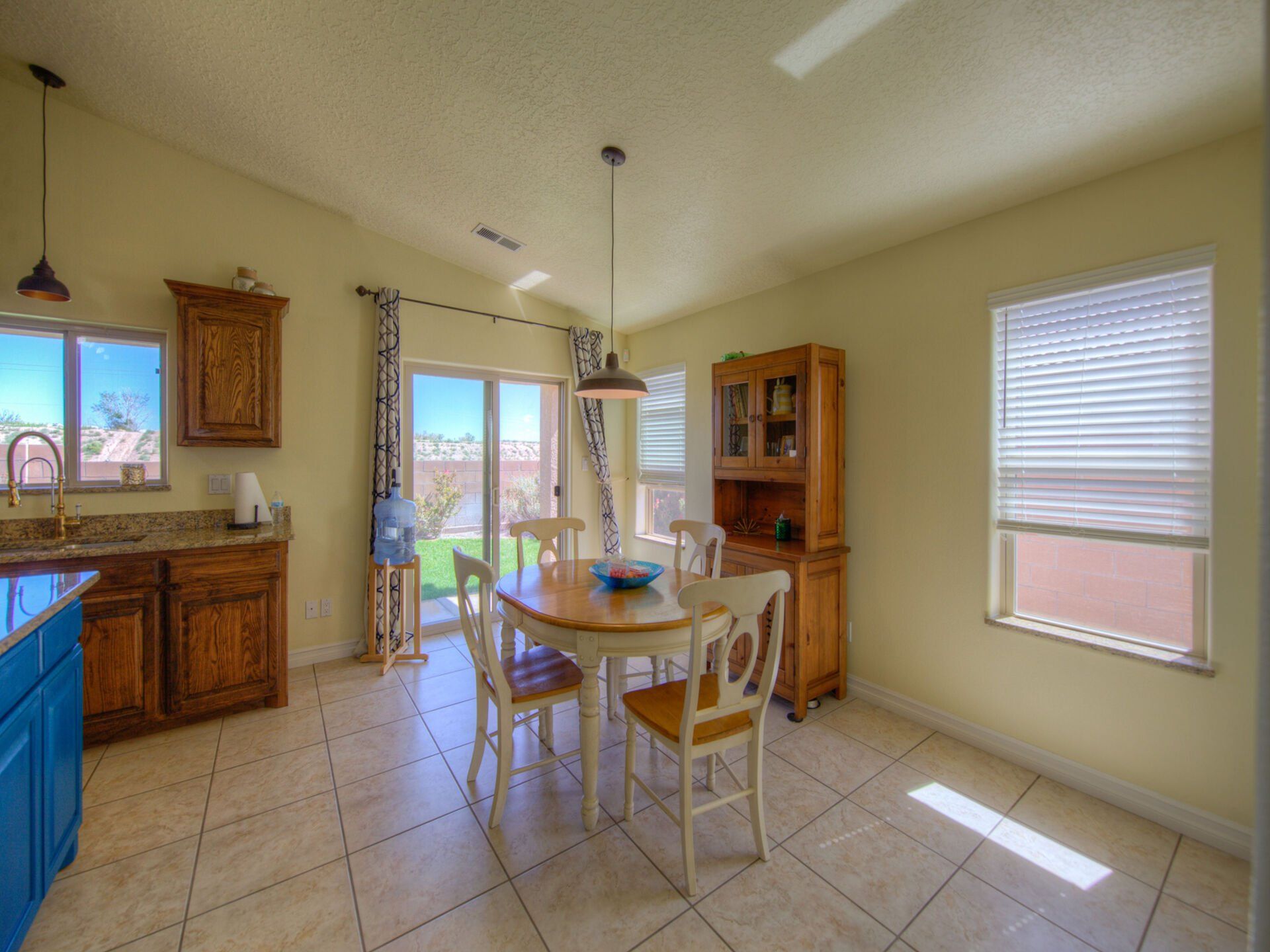 A kitchen with a table and chairs in it