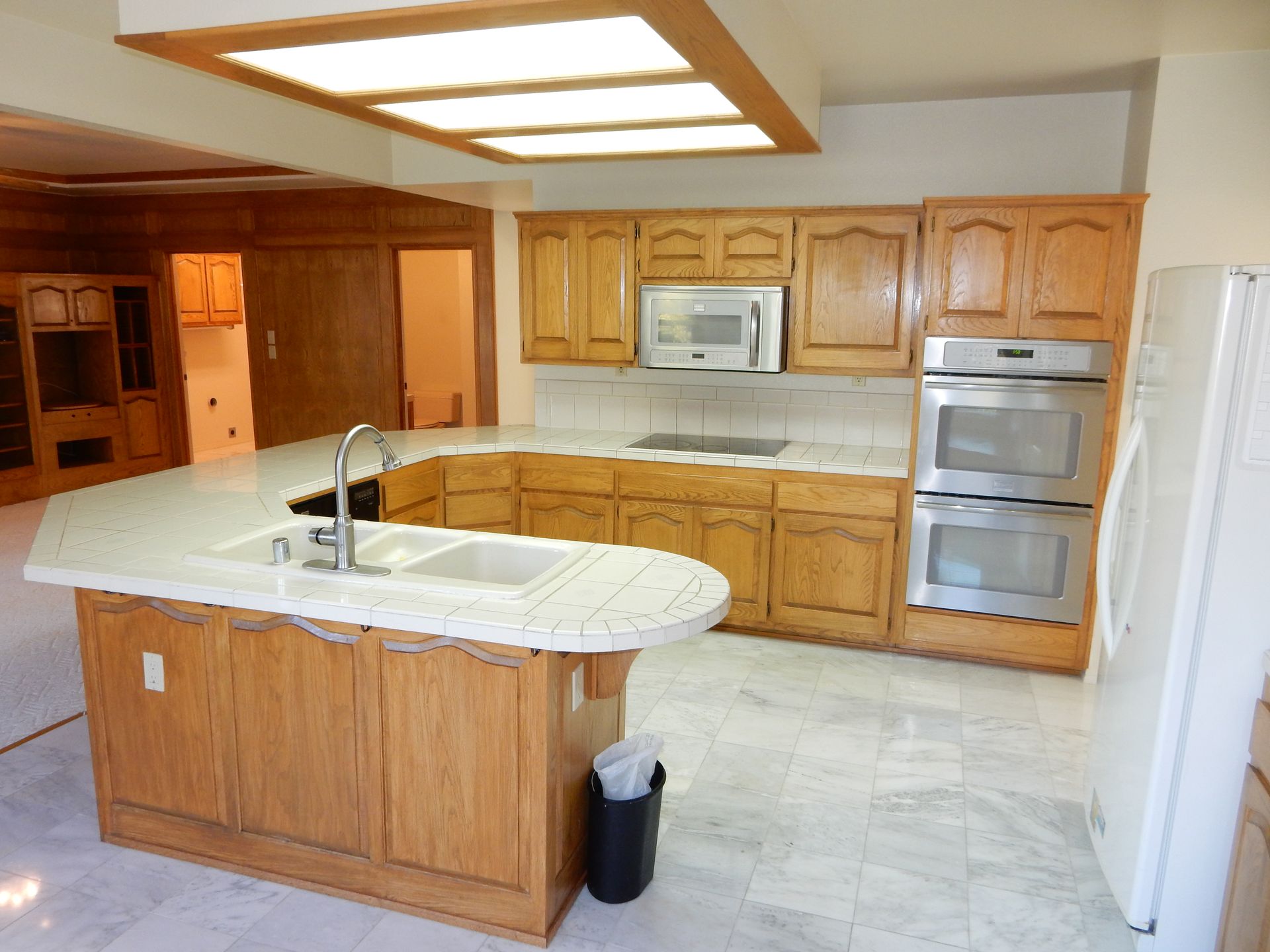 A kitchen with wooden cabinets and stainless steel appliances