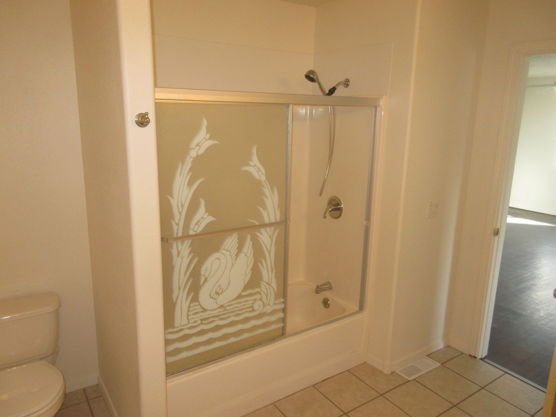 A bathroom with a toilet , shower and bathtub.