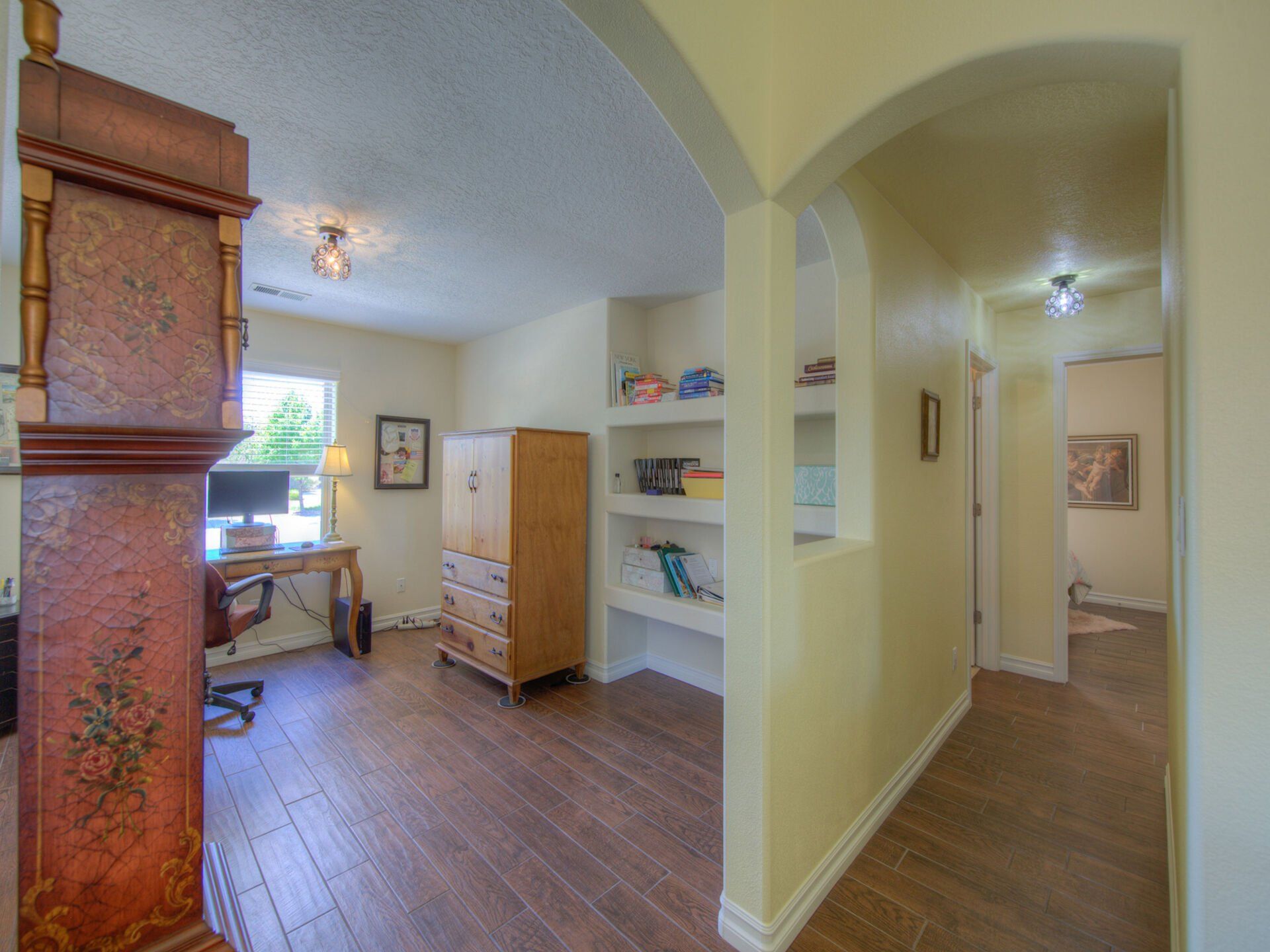 There is a large grandfather clock in the middle of the room.