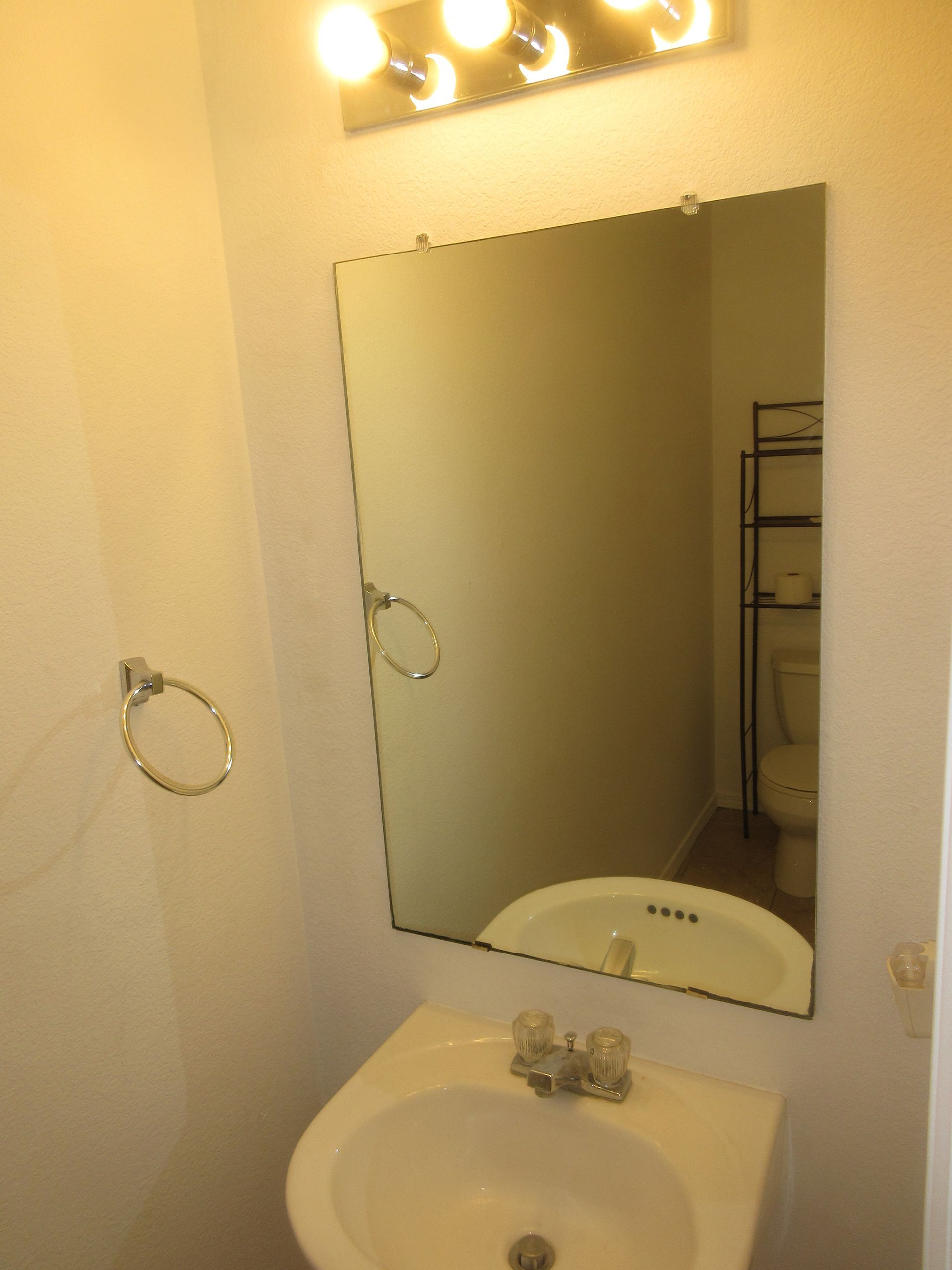 A bathroom with a sink and a large mirror