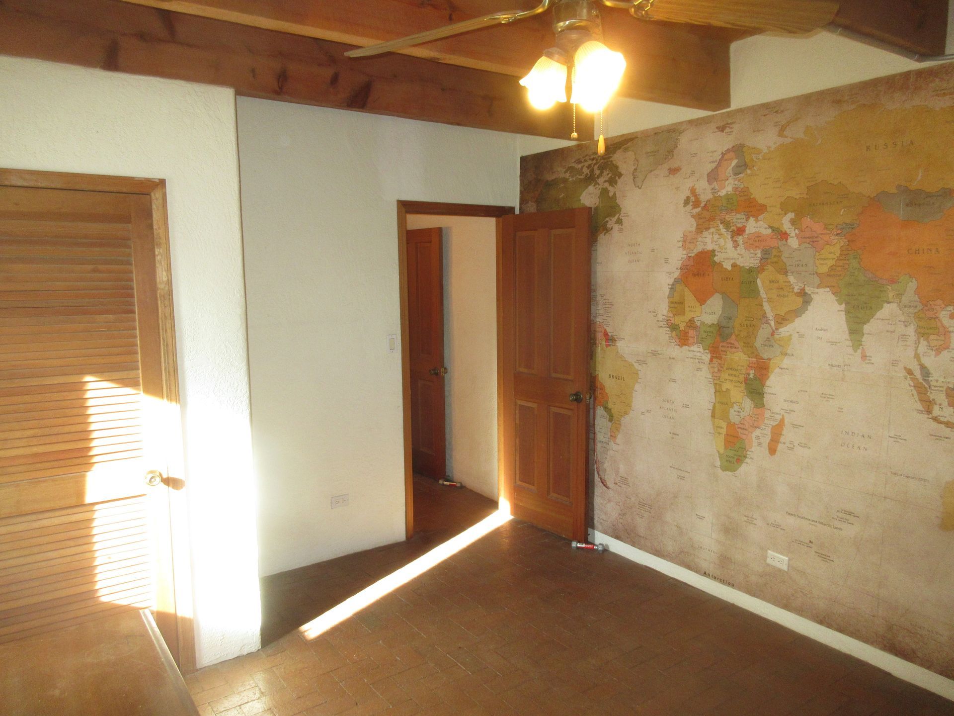 An empty room with a large map on the wall