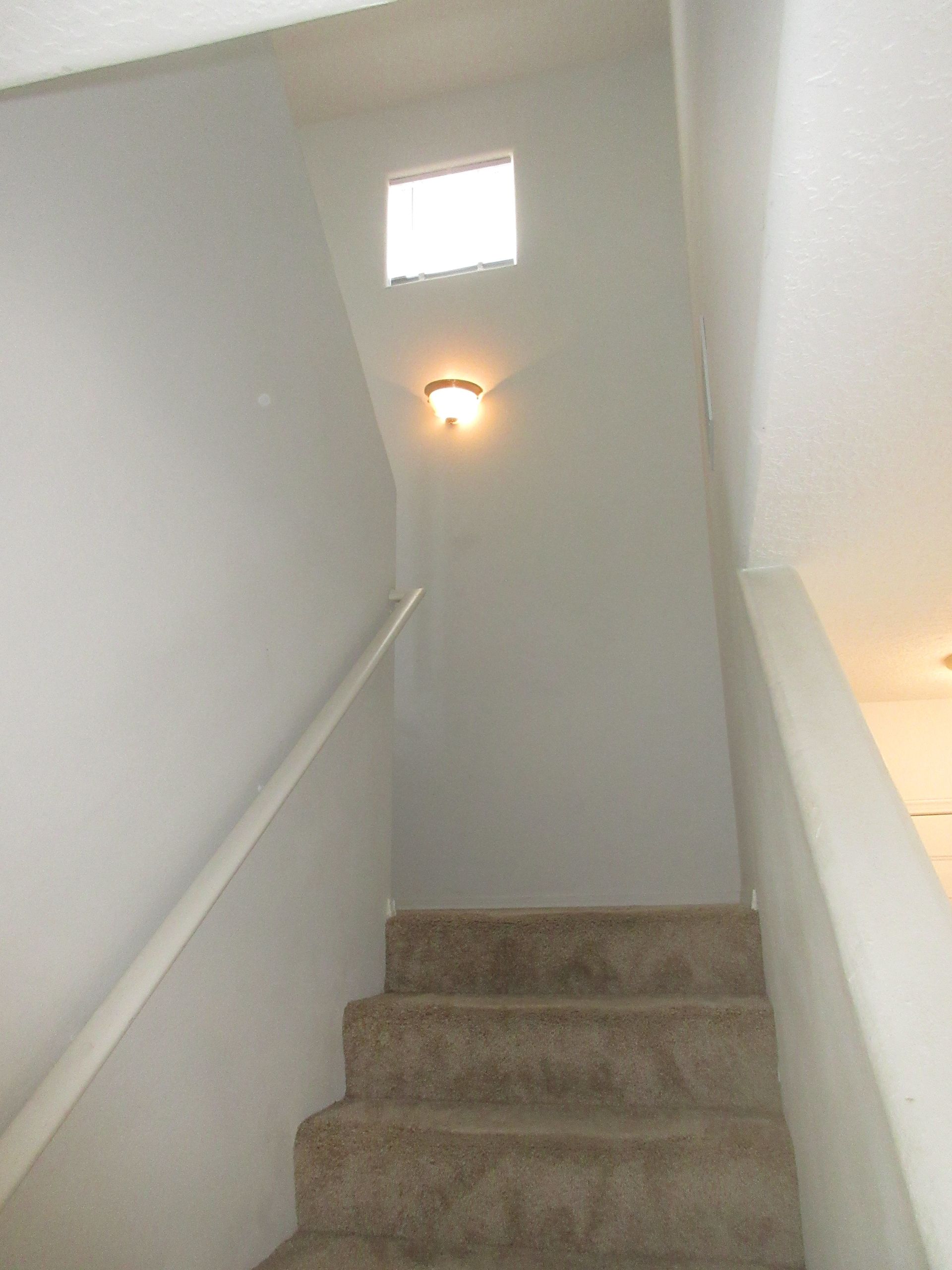 A set of stairs leading up to the second floor of a house.