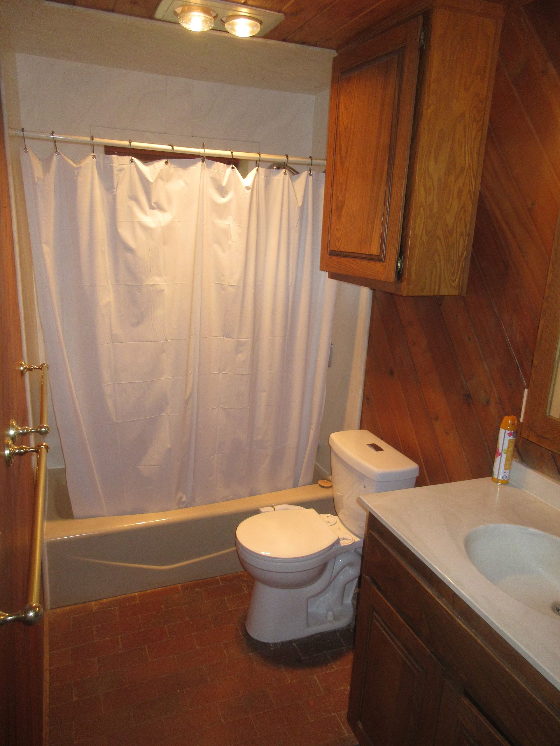 A bathroom with a toilet a sink and a bathtub