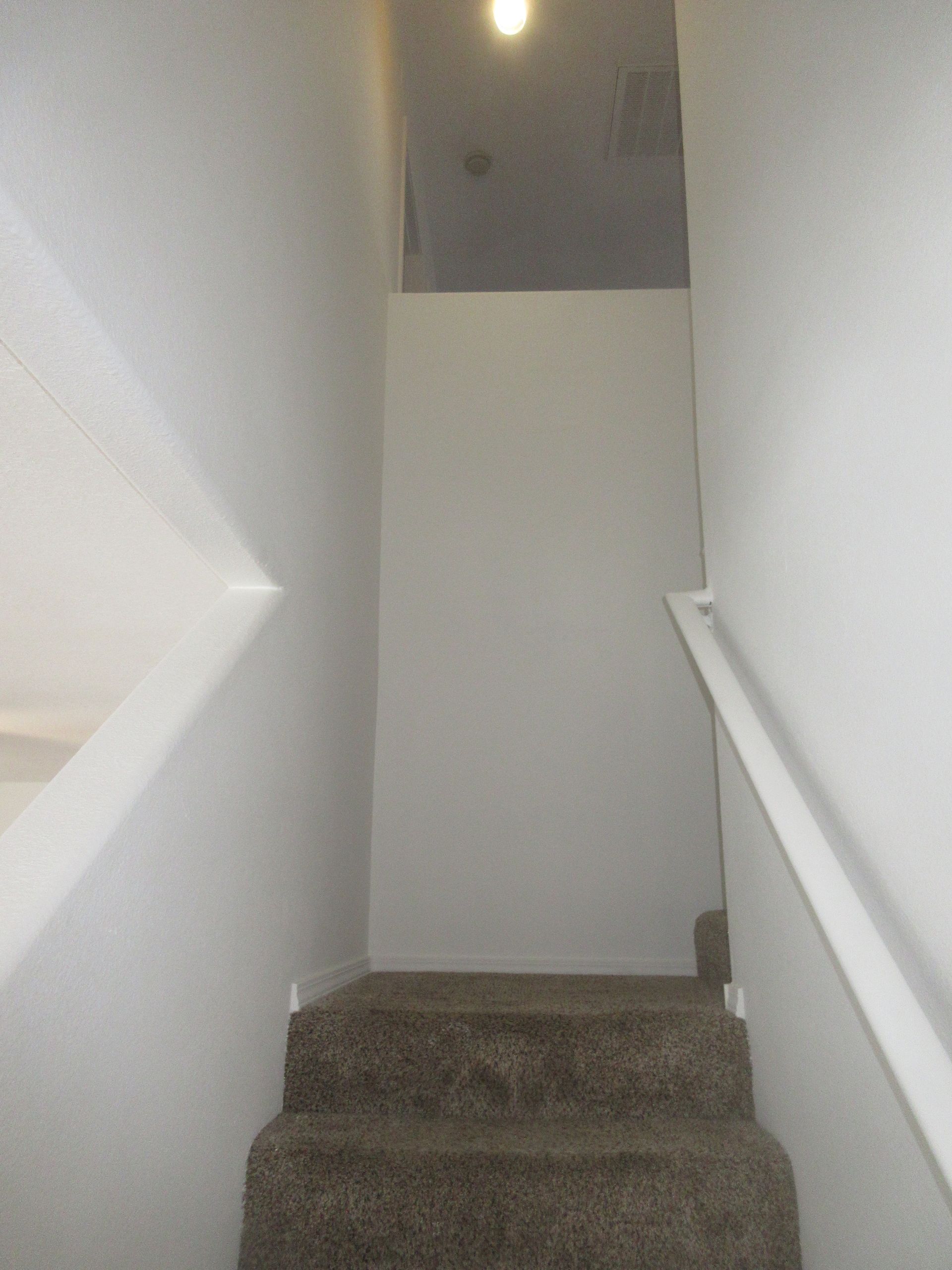 A set of stairs leading up to the second floor of a house.