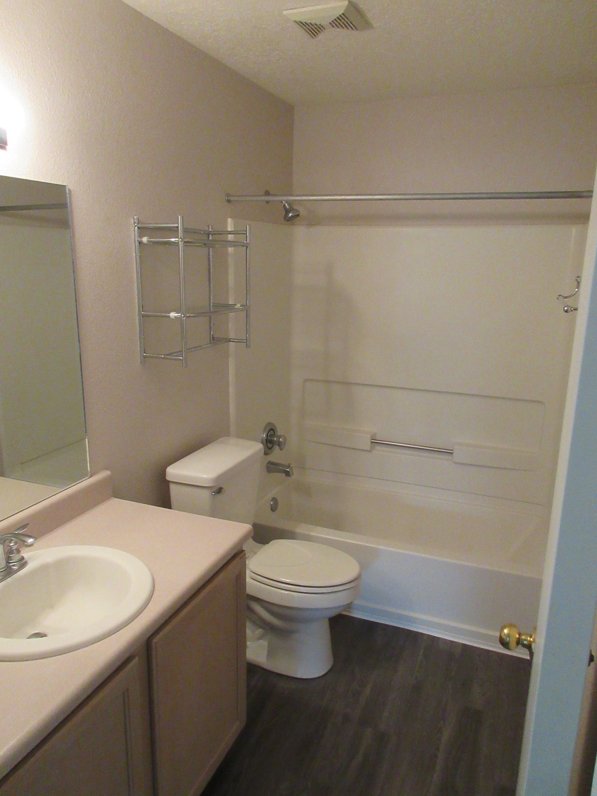 A bathroom with a toilet a sink and a bathtub