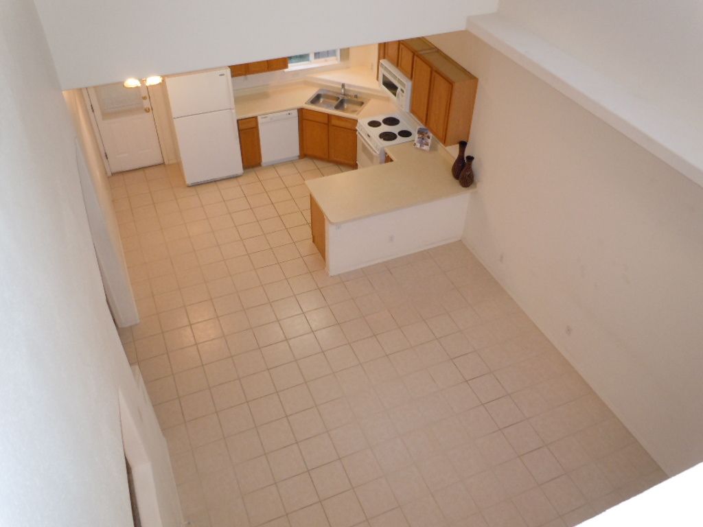 An aerial view of an empty kitchen with tile floors