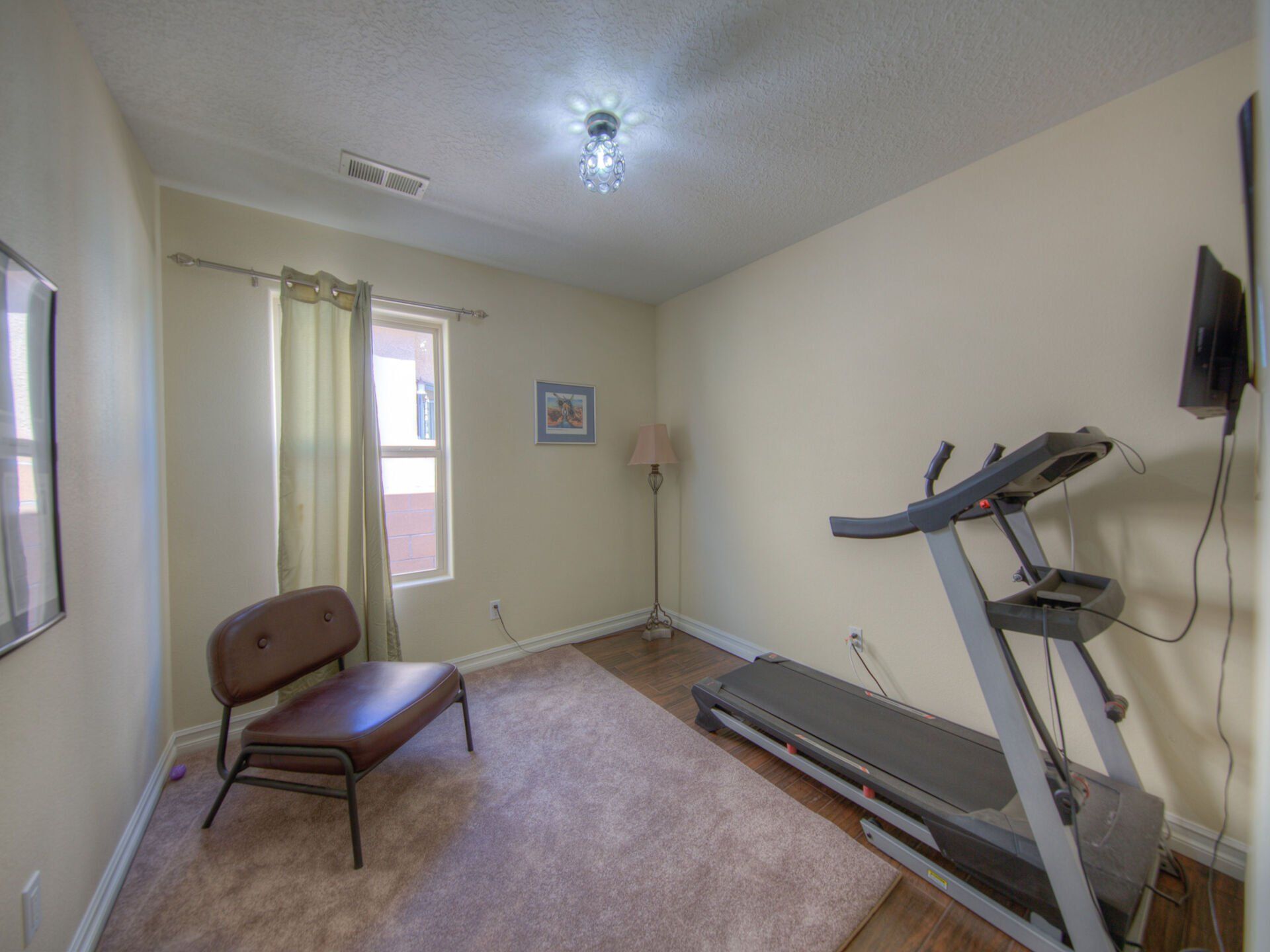 There is a treadmill in the middle of the room.