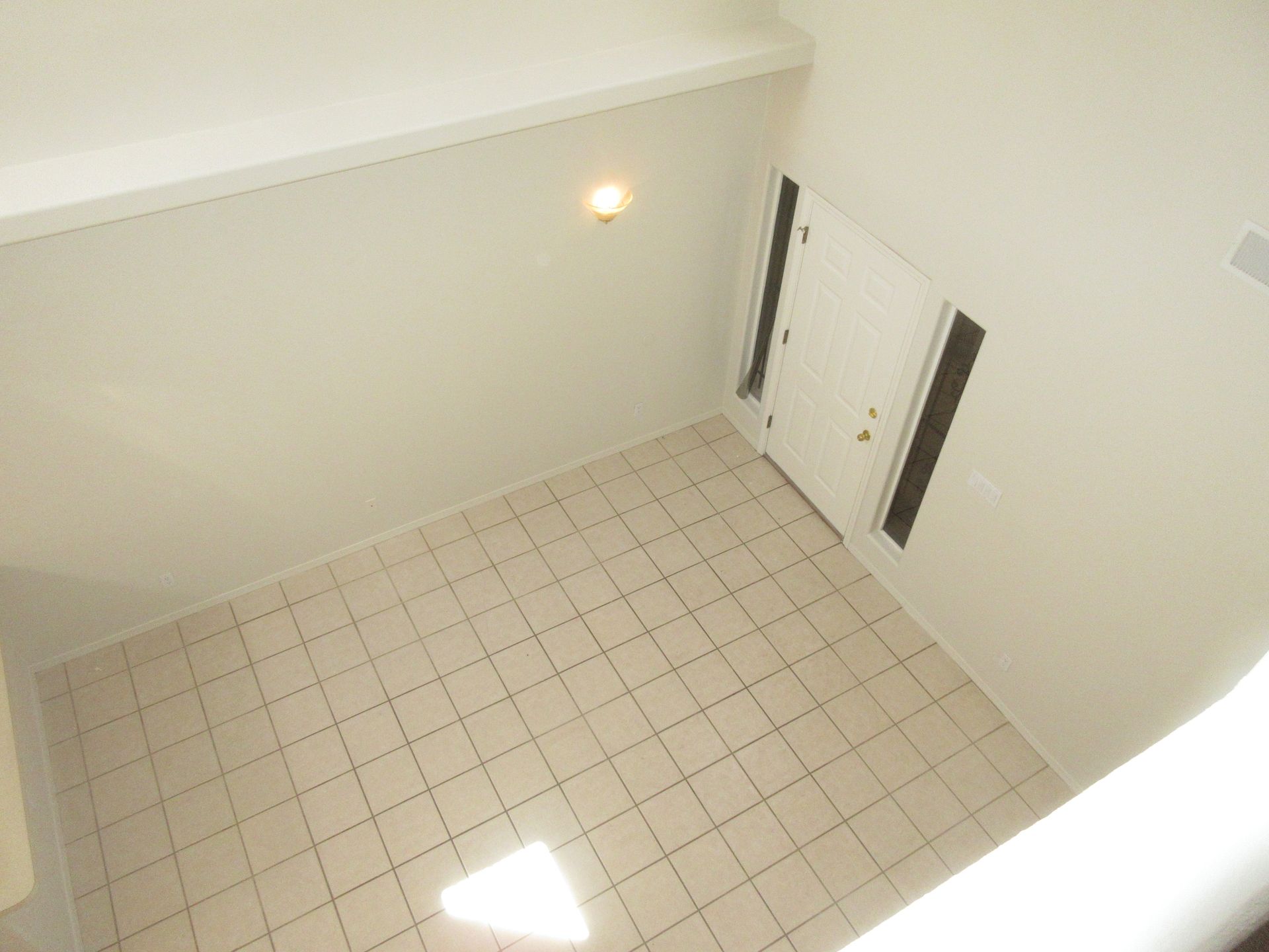 An aerial view of an empty room with a tiled floor