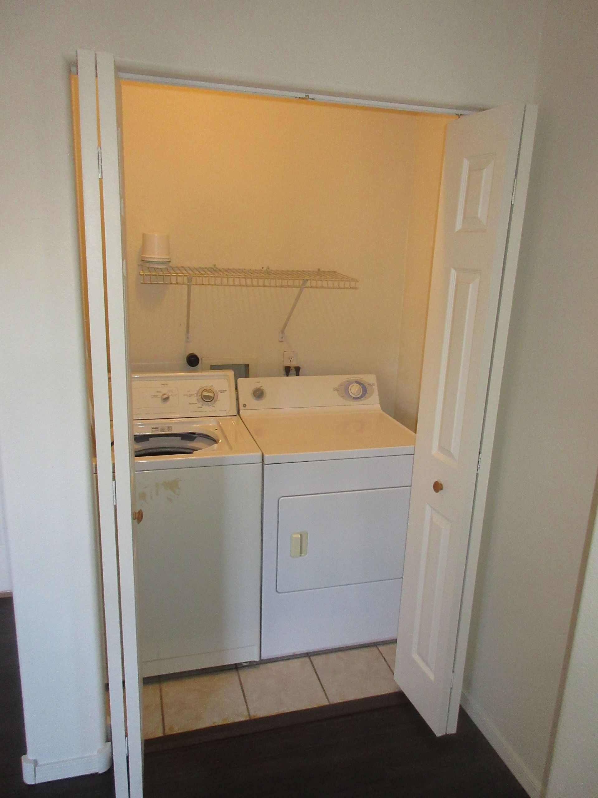 A laundry room with a washer and dryer in it