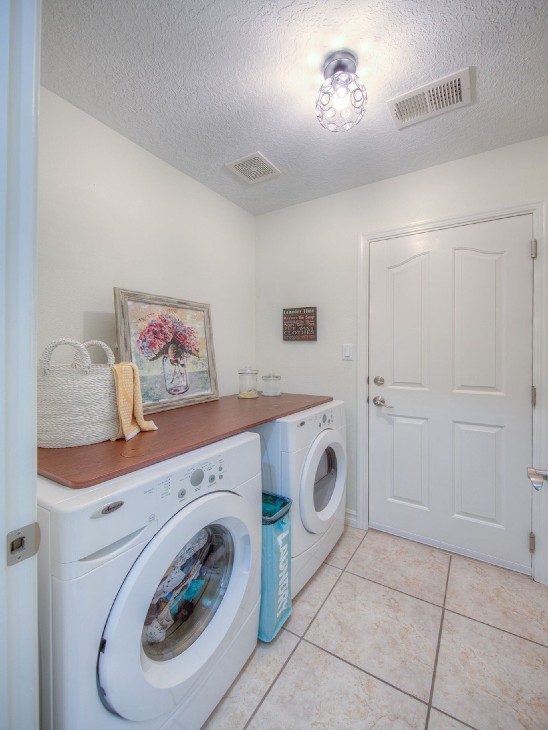 A laundry room with a washing machine and a dryer
