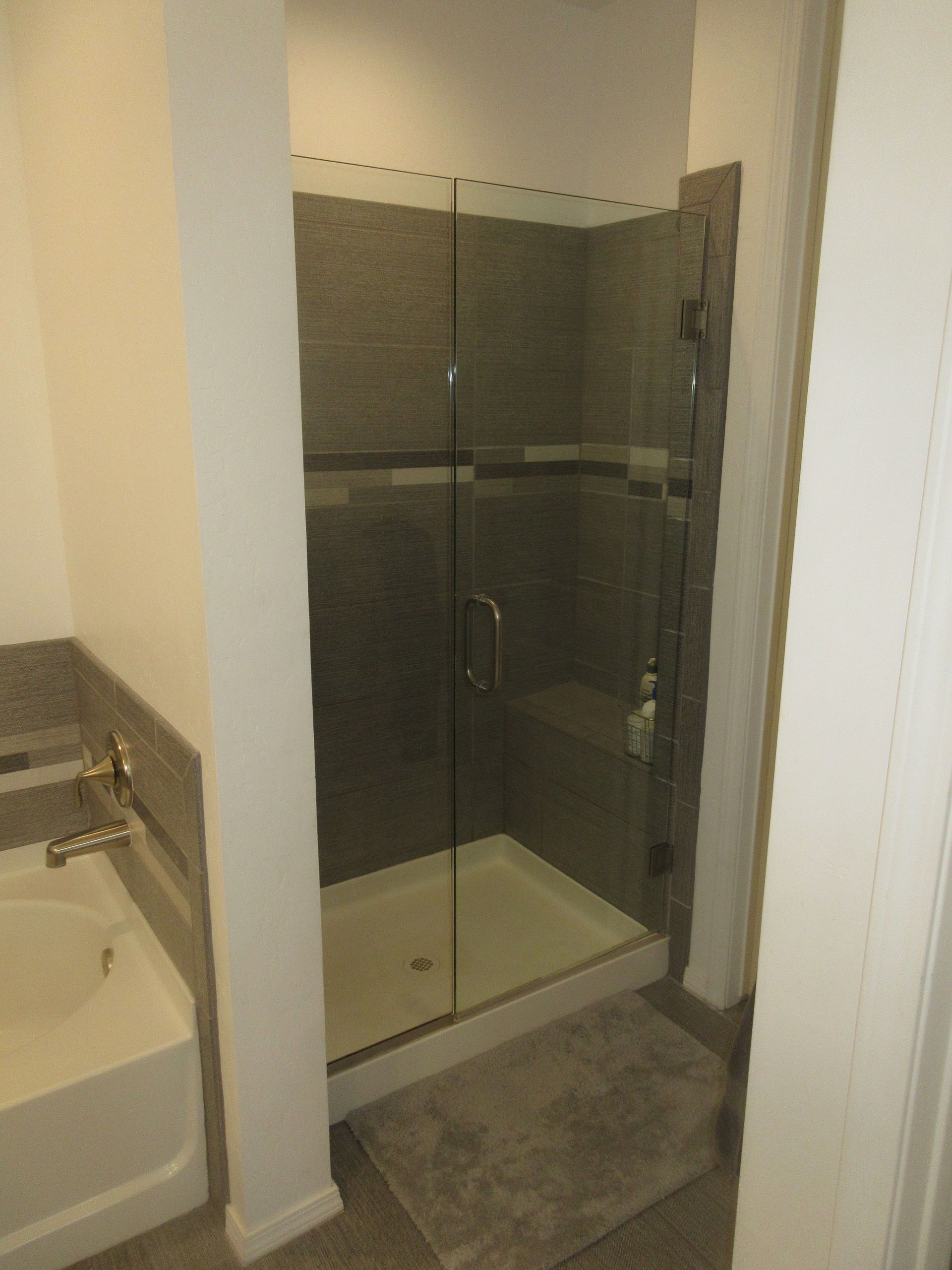 A bathroom with a bathtub and a walk in shower