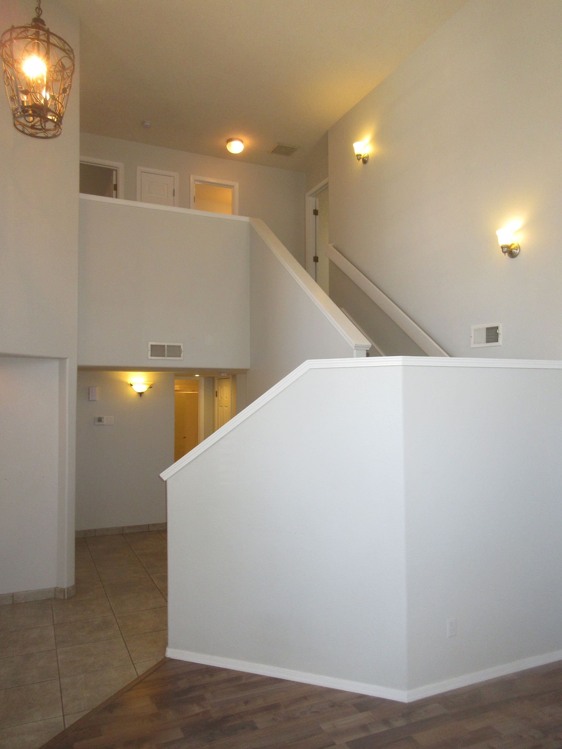 An empty room with stairs leading up to the second floor