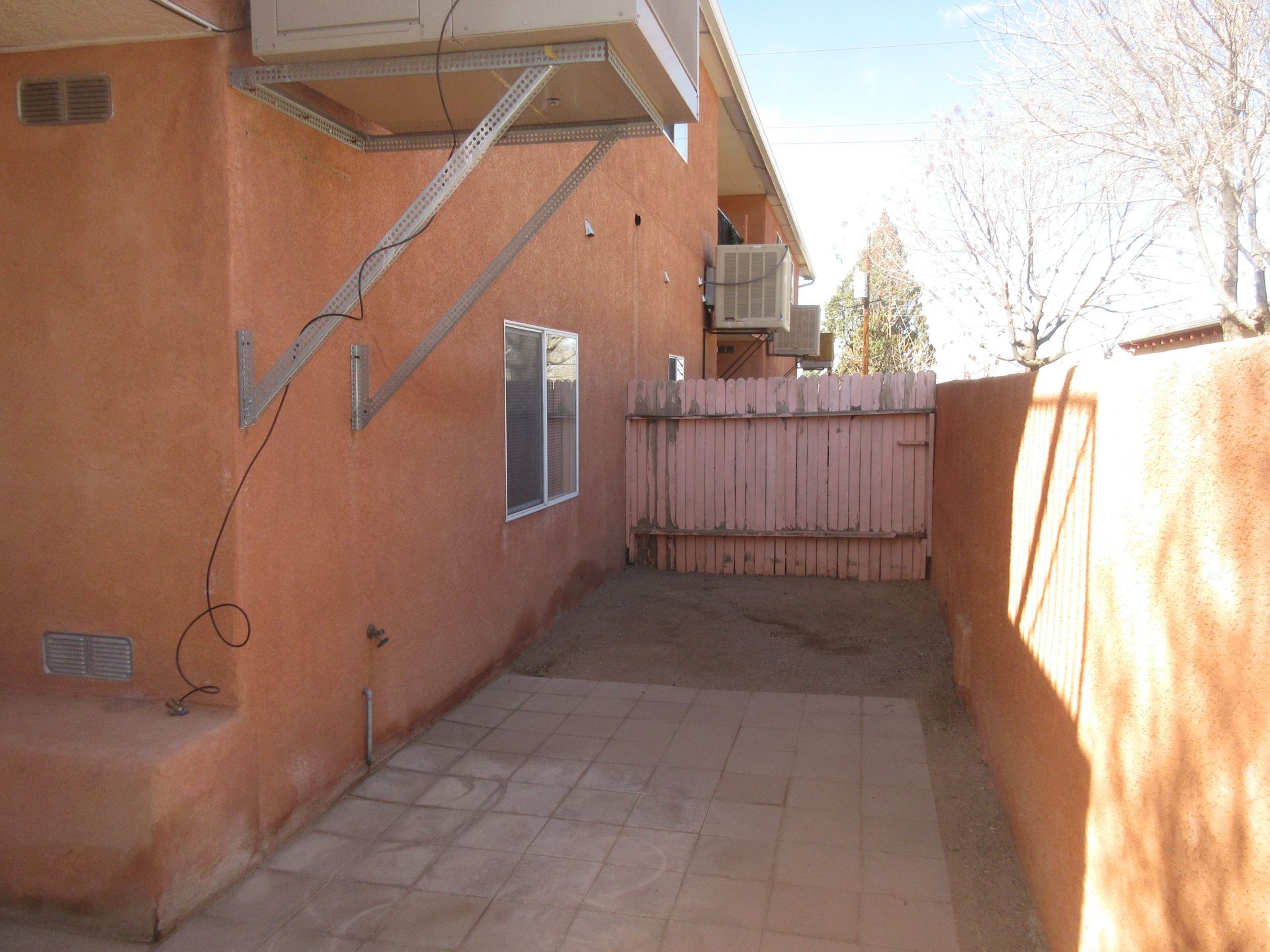 A building with a pink fence behind it