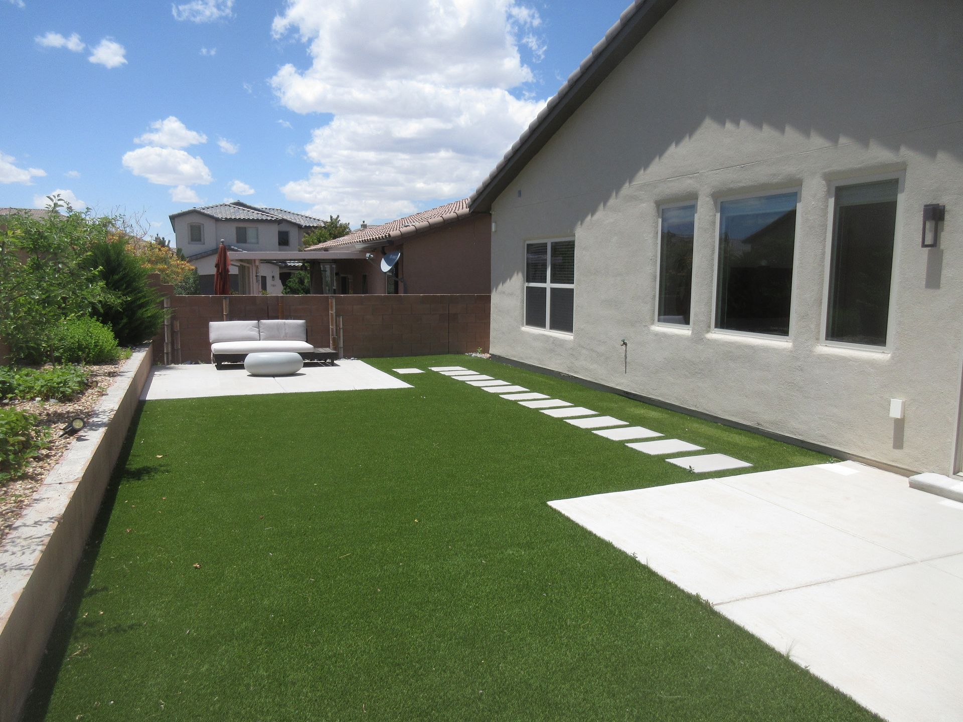 A house with a large lawn in front of it