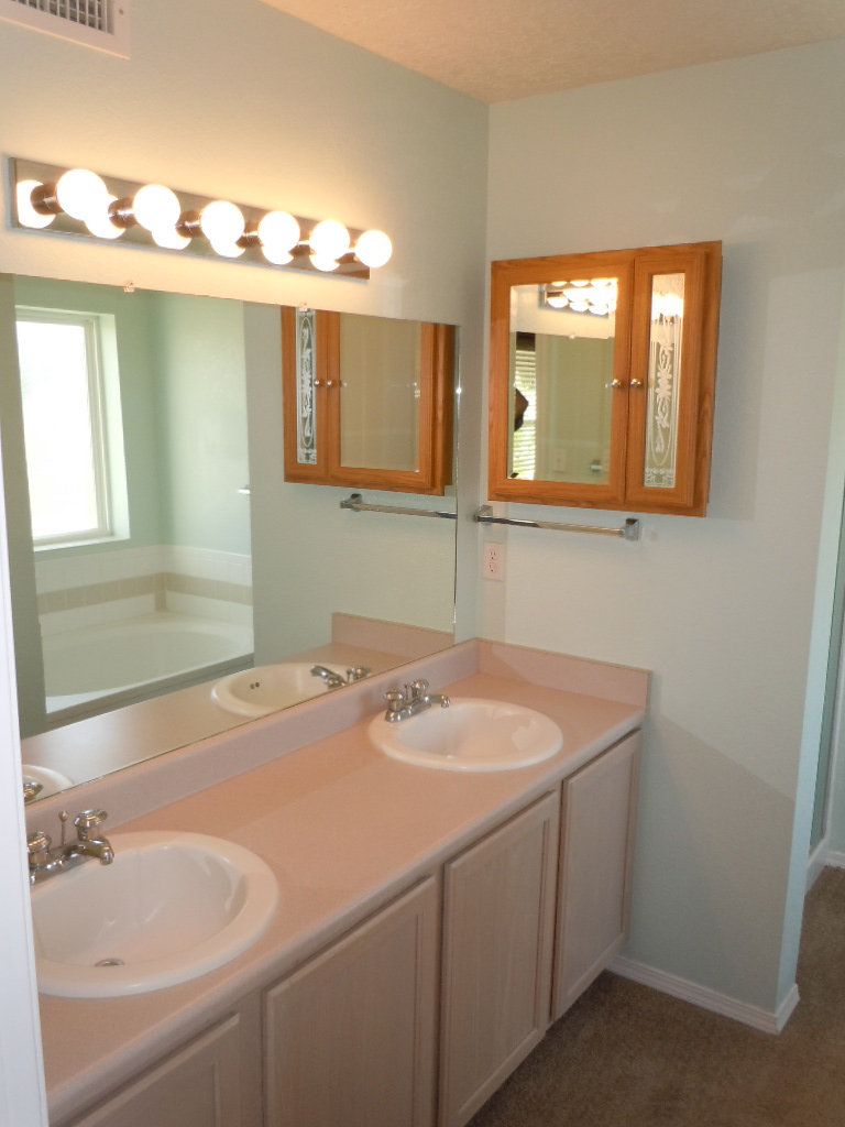A bathroom with two sinks and a mirror