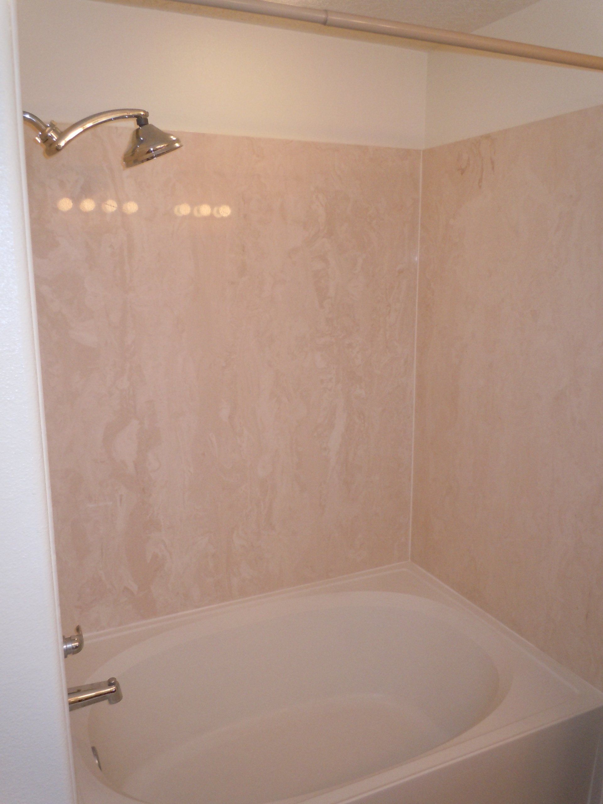 A bathroom with a bathtub and a shower head