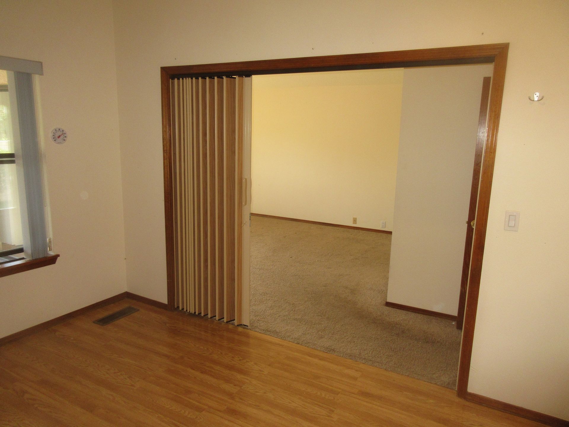 An empty room with a sliding door and a window
