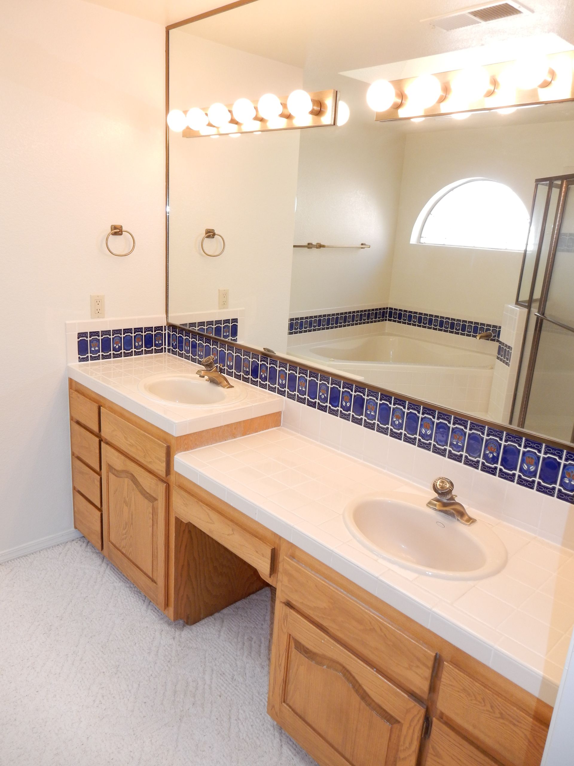 A bathroom with two sinks and a large mirror
