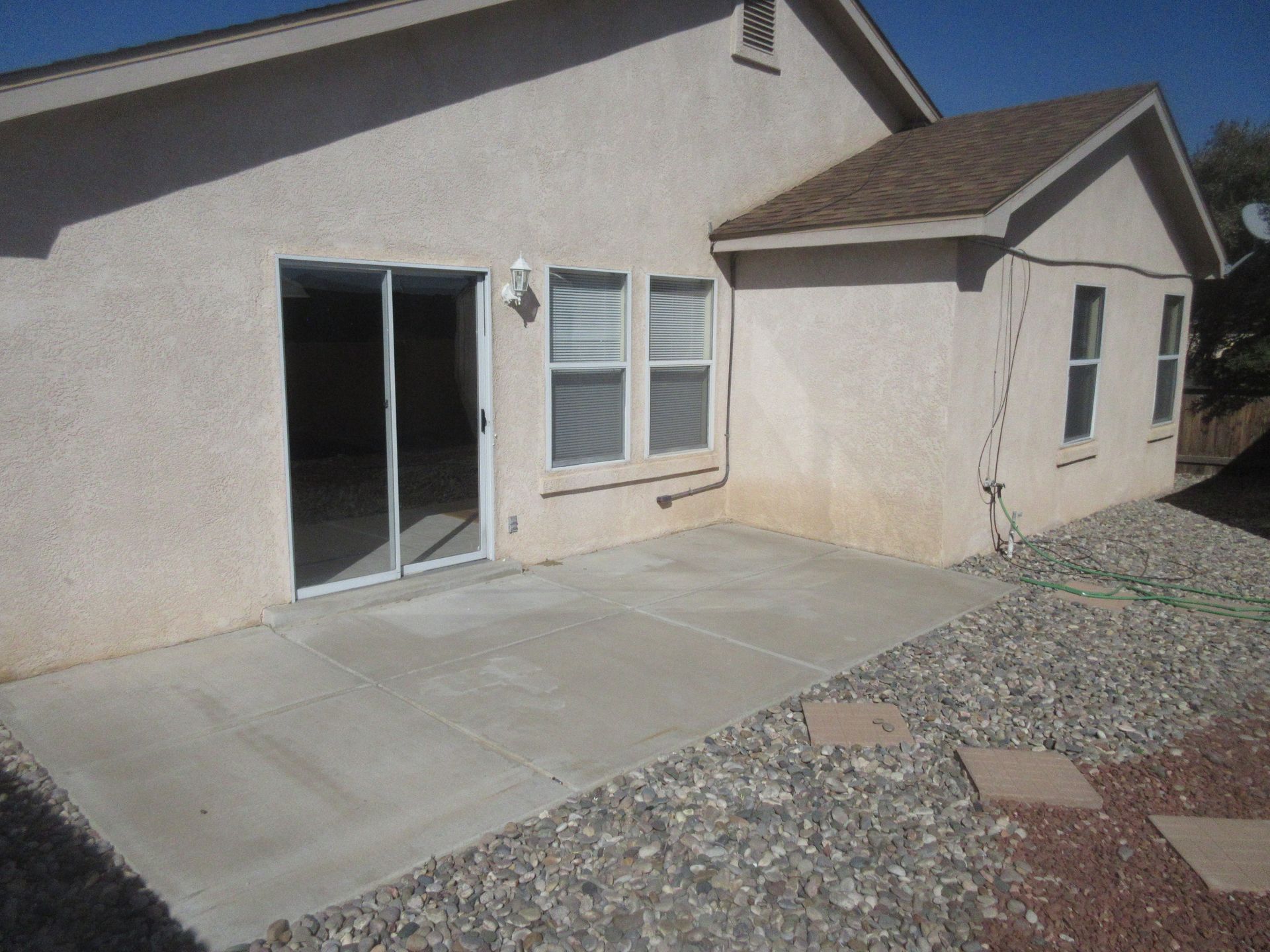 A house with a patio and sliding glass doors