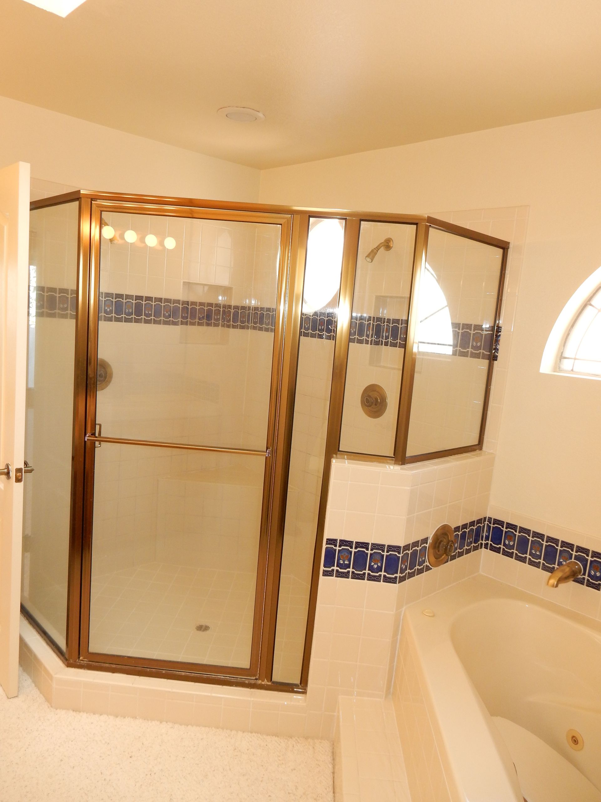 A bathroom with a tub and a walk in shower