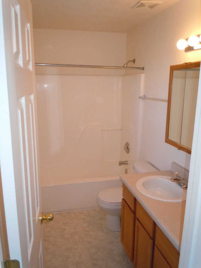 A bathroom with a sink , toilet and bathtub