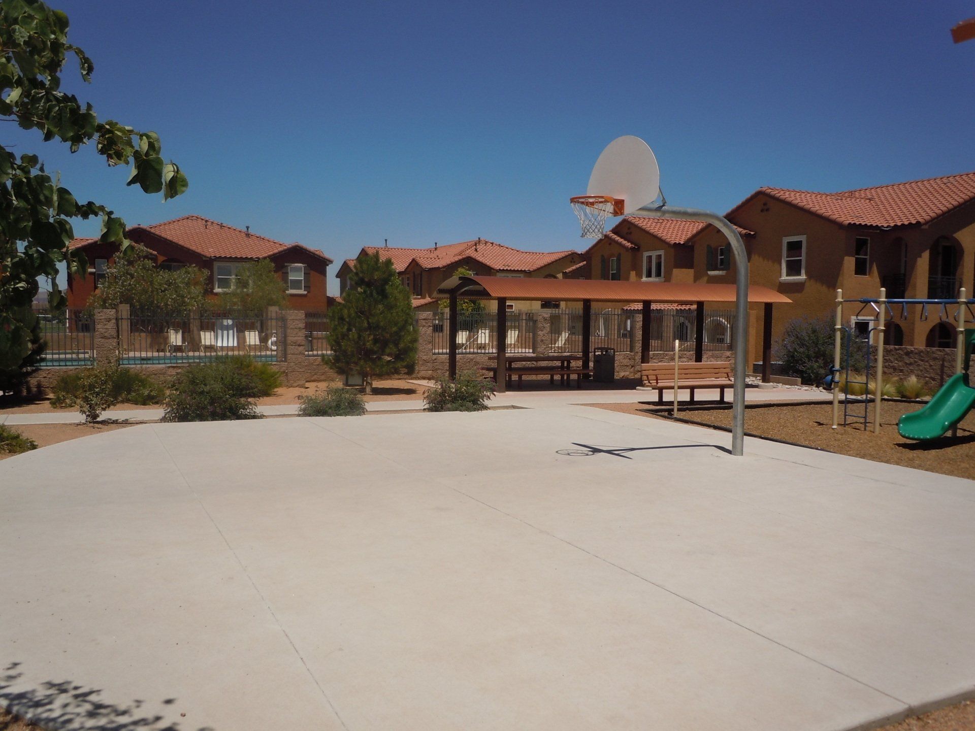 A playground with a basketball hoop in the middle of it
