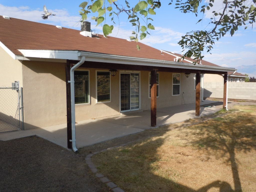 A house with a covered patio in the backyard