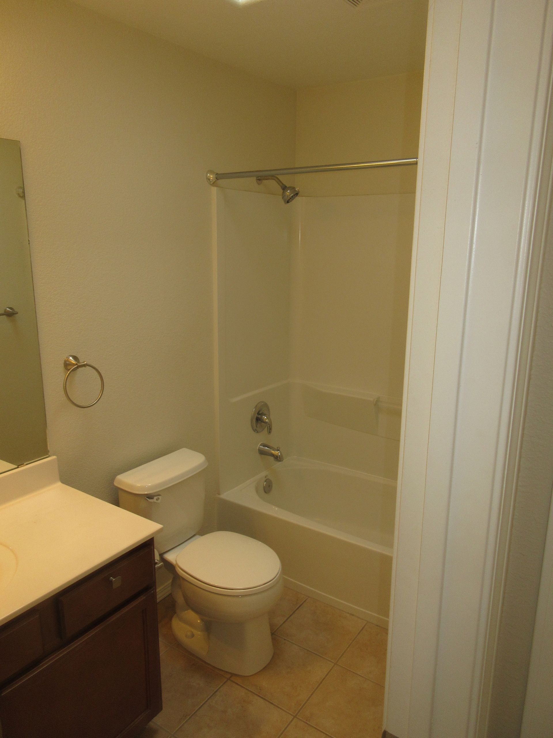 A bathroom with a toilet a sink and a bathtub