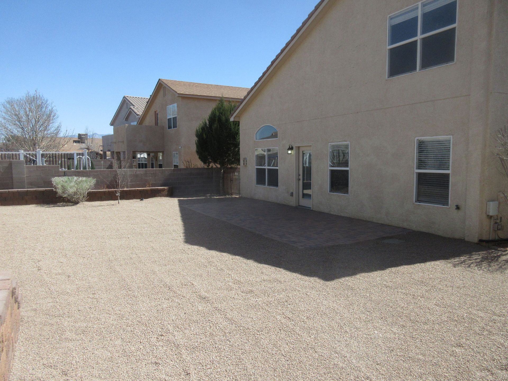 A house with a gravel driveway in front of it
