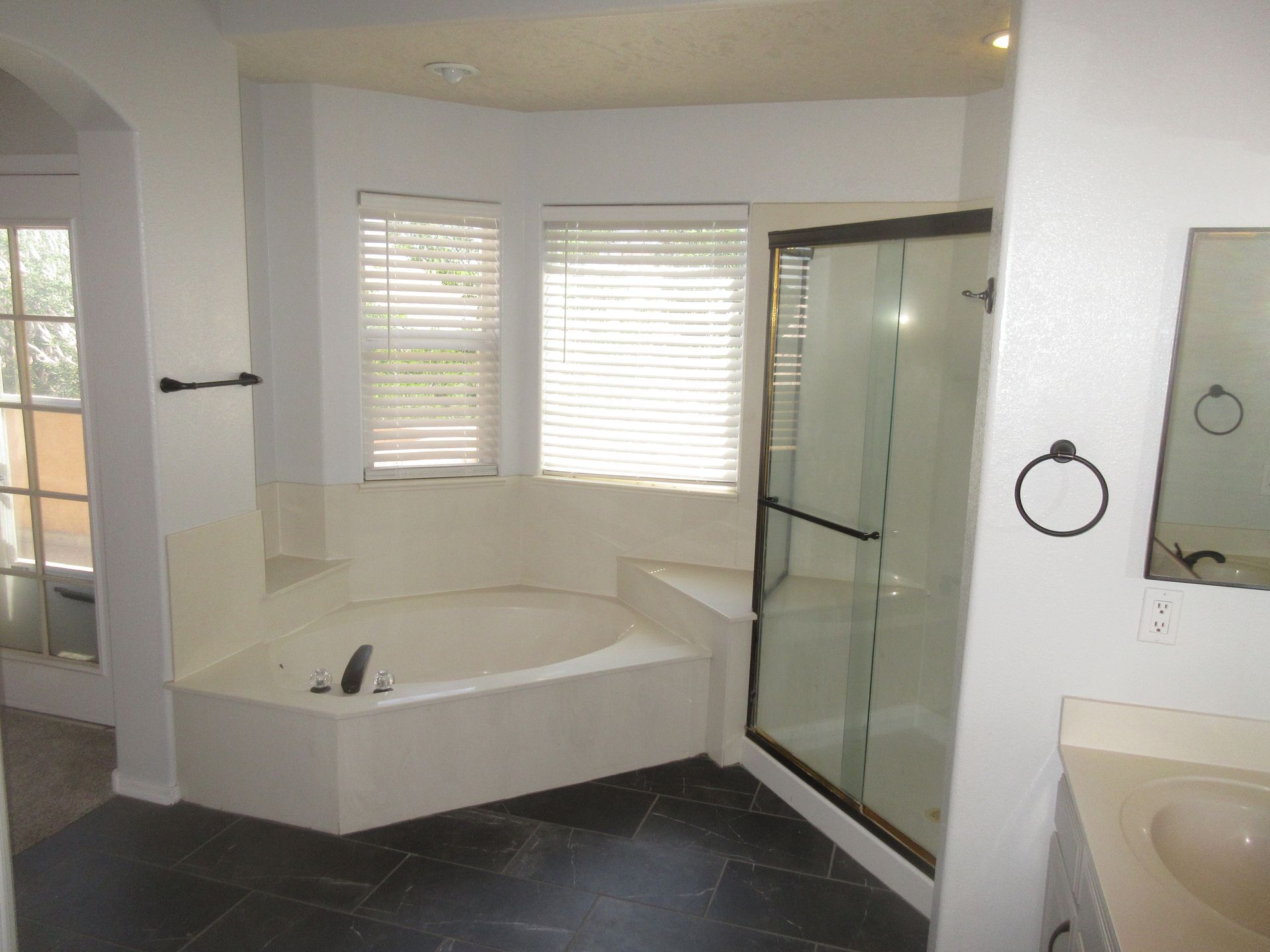 A bathroom with a jacuzzi tub and a walk in shower