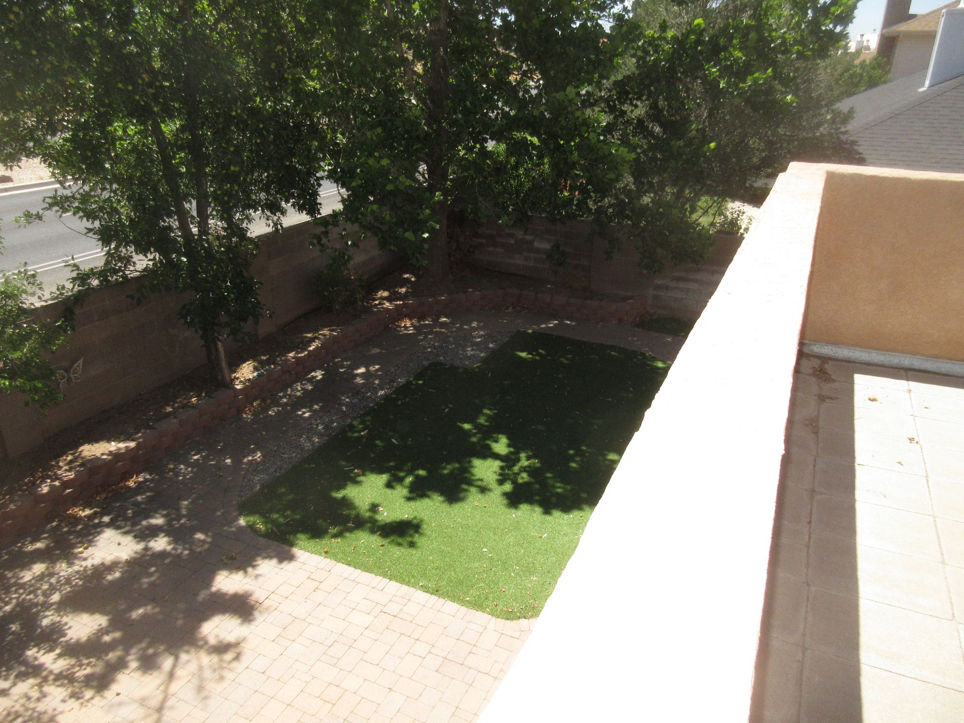 An aerial view of a backyard with trees and grass