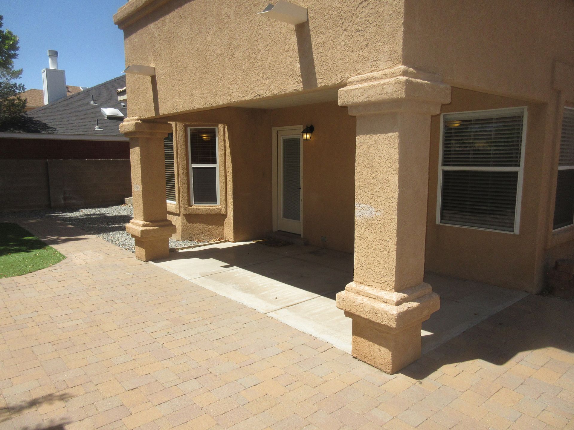 A house with a patio and columns in front of it