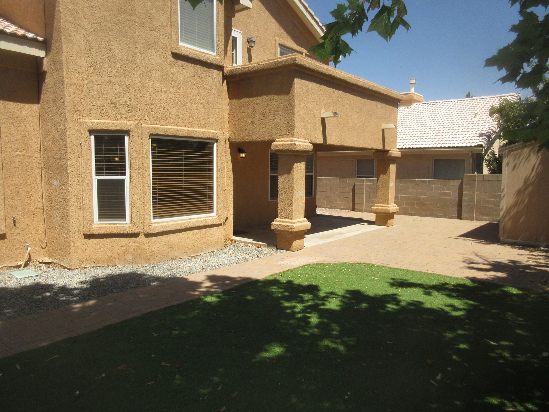 A large house with a lot of windows and a patio