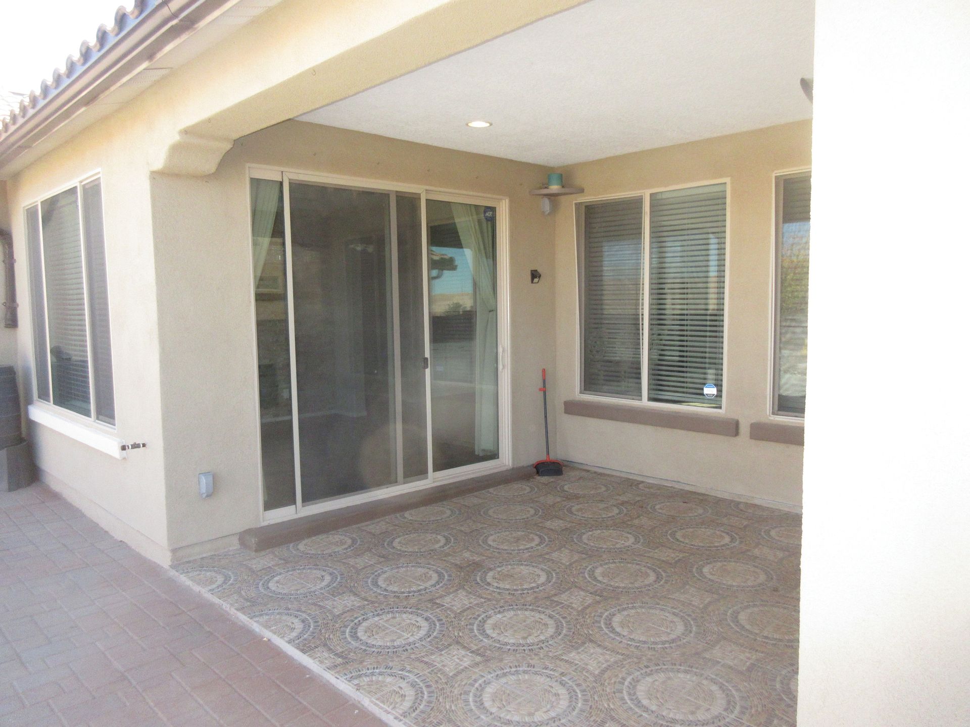 A house with a patio and sliding glass doors