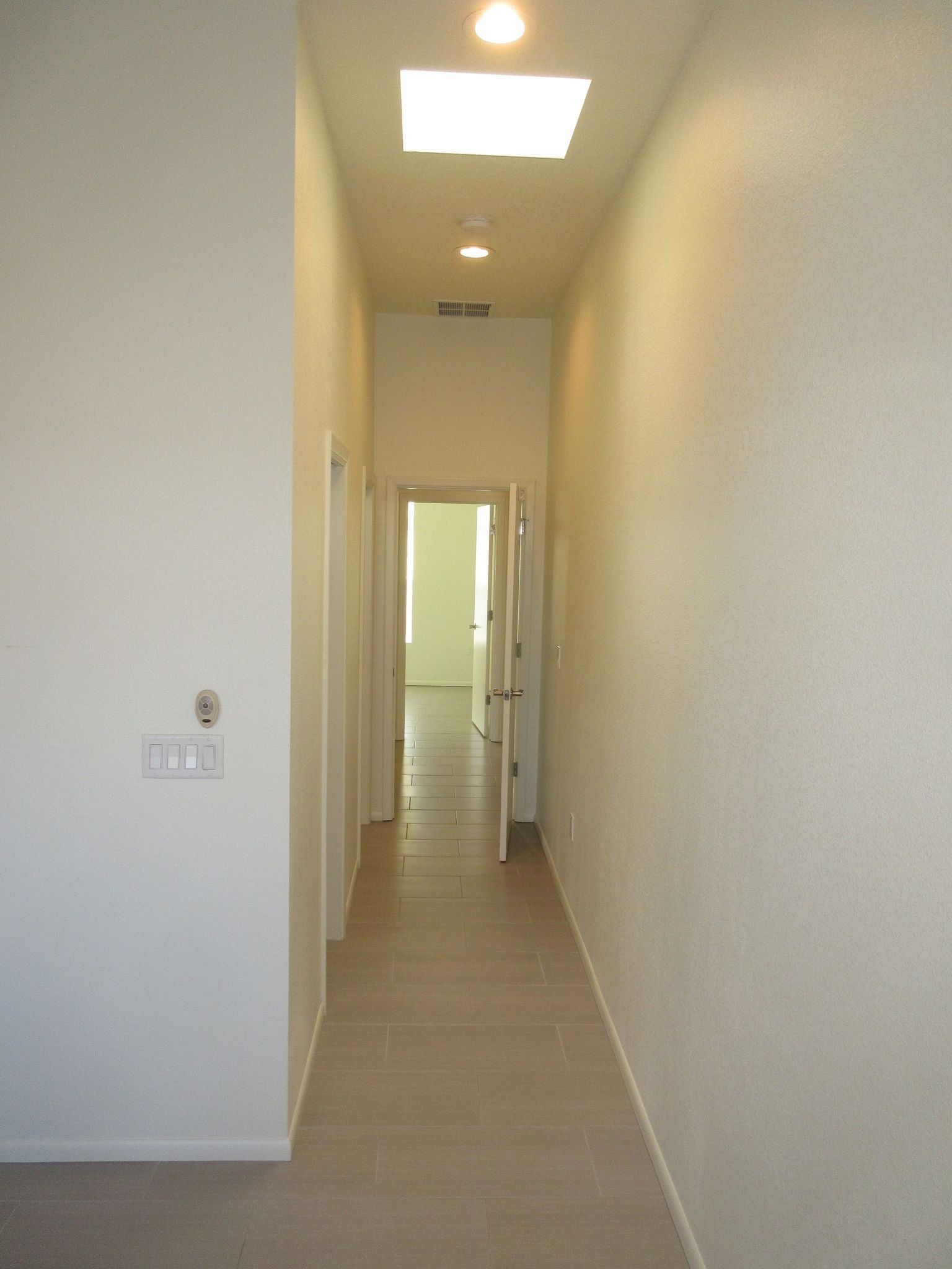 A long hallway with a skylight in the ceiling