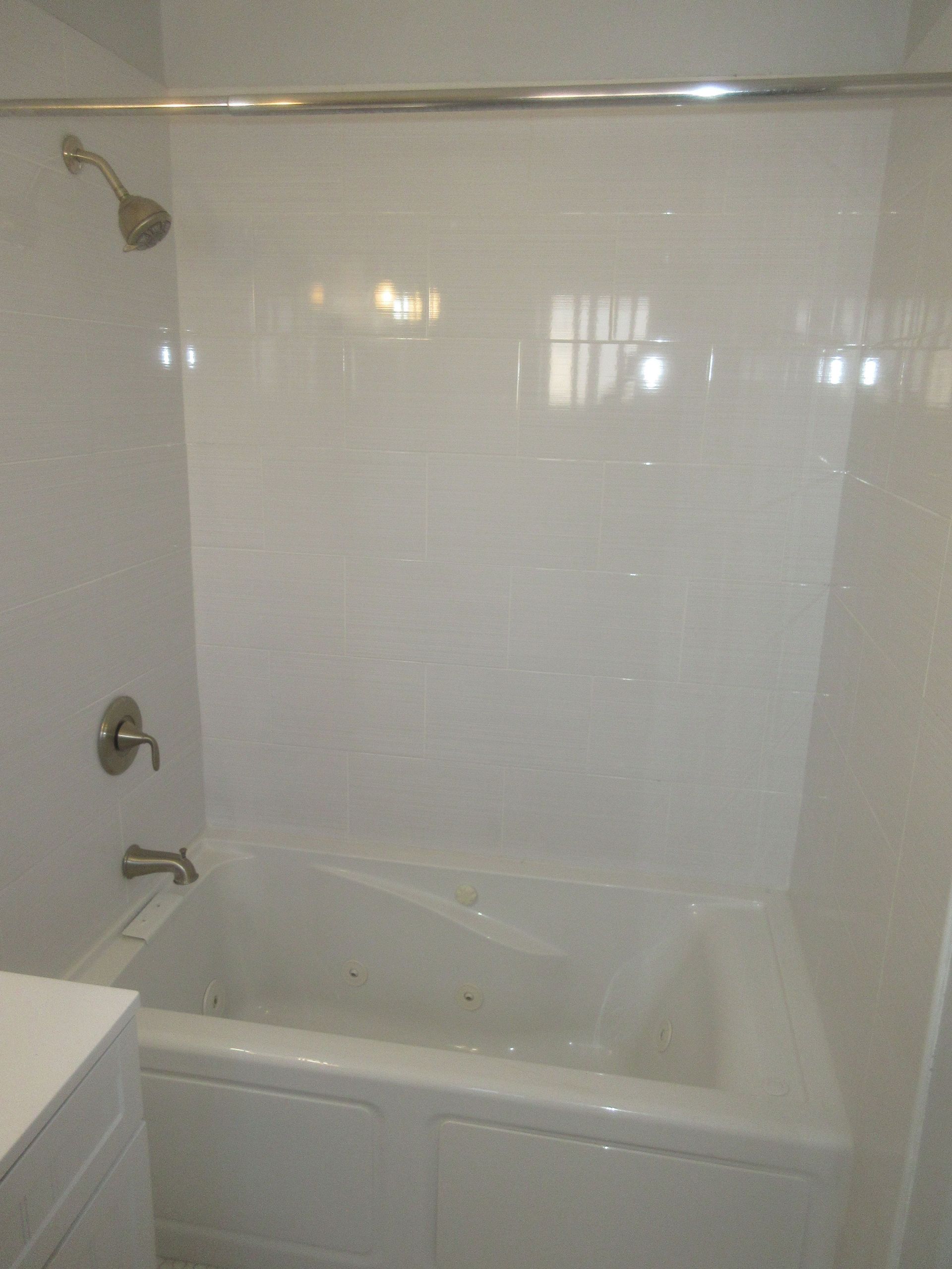 A bathroom with a bathtub and a shower.