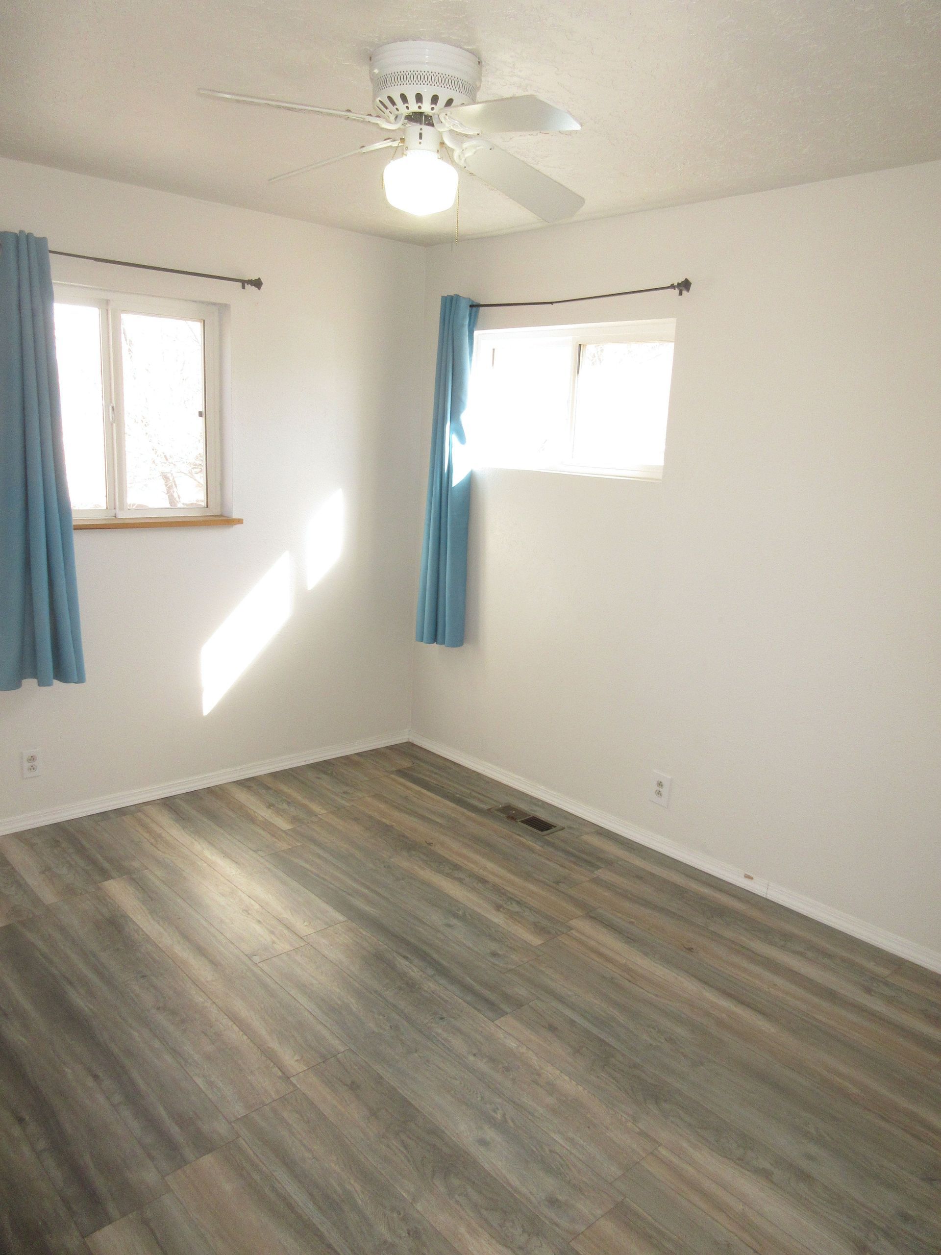 There is a ceiling fan in the room and a window.