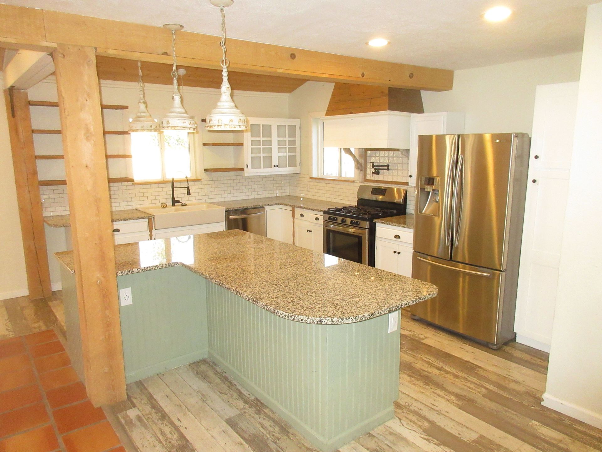 A kitchen with stainless steel appliances and granite counter tops