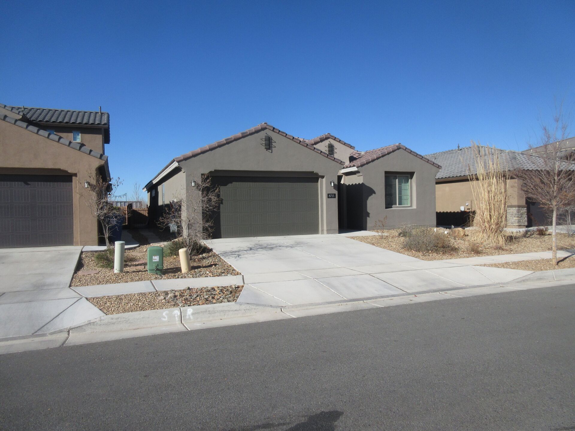 A house in a residential area with a blue sky in the background