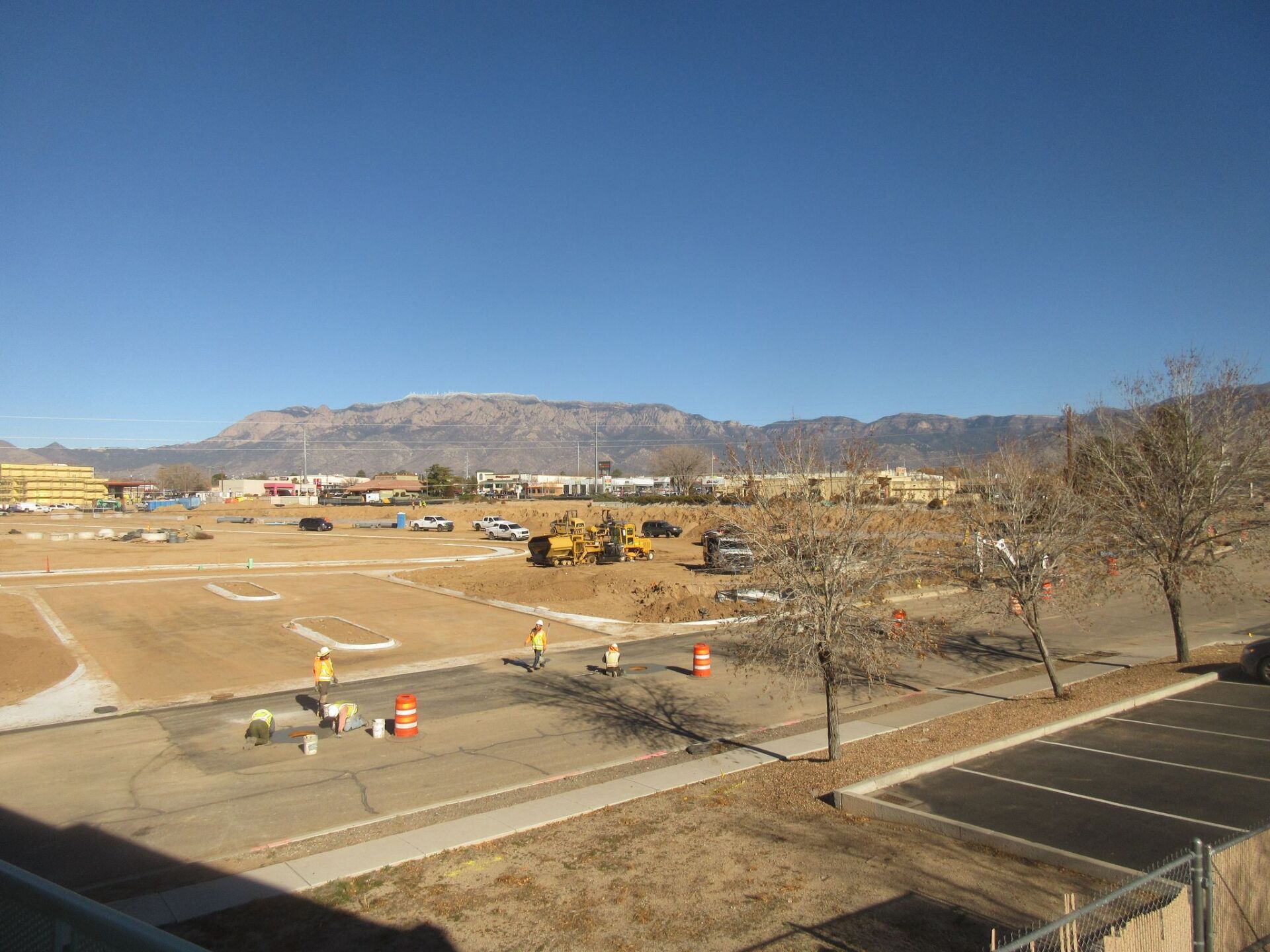 A view of a construction site with mountains in the background