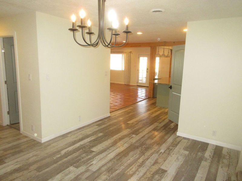 There is a chandelier in the middle of the room.